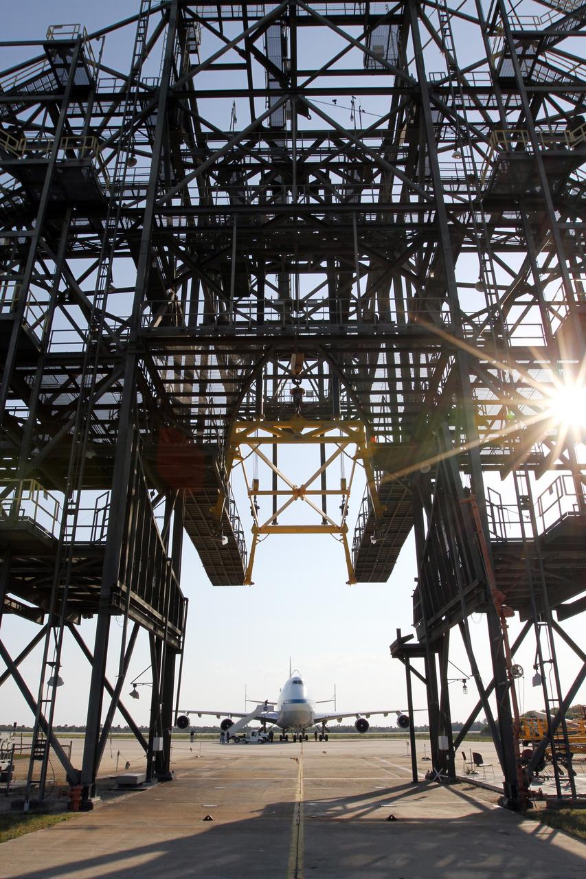 CAPE CANAVERAL, Fla. – The newly arrived Shuttle Carrier Aircraft is seen through the platforms of the mate-demate device at the Shuttle Landing Facility at NASA’s Kennedy Space Center in Florida.    The aircraft, known as an SCA, arrived at 5:35 p.m. EDT to prepare for shuttle Discovery’s ferry flight to the Washington Dulles International Airport in Sterling, Va., on April 17. This SCA, designated NASA 905, is a modified Boeing 747 jet airliner, originally manufactured for commercial use. One of two SCAs employed over the course of the Space Shuttle Program, NASA 905 is assigned to the remaining ferry missions, delivering the shuttles to their permanent public display sites.  NASA 911 was decommissioned at the NASA Dryden Flight Research Center in California in February. Discovery will be placed on permanent public display in the Smithsonian's National Air and Space Museum Steven F. Udvar-Hazy Center in Chantilly, Va.  For more information on the SCA, visit http://www.nasa.gov/centers/dryden/news/FactSheets/FS-013-DFRC.html. For more information on shuttle transition and retirement activities, visit http://www.nasa.gov/shuttle. Photo credit: NASA/Kim Shiflett