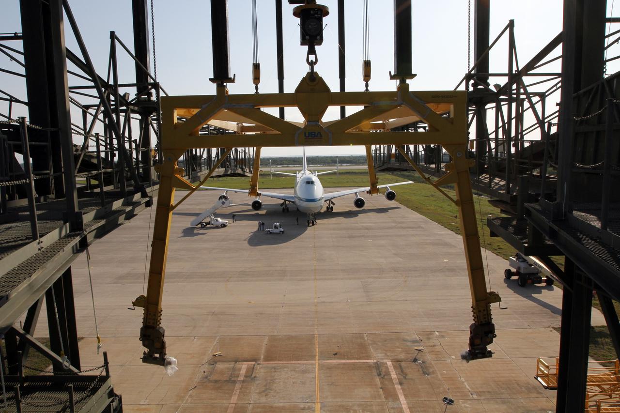 CAPE CANAVERAL, Fla. – The newly arrived Shuttle Carrier Aircraft is framed by a grappling fixture on the mate-demate device at the Shuttle Landing Facility at NASA’s Kennedy Space Center in Florida. The aircraft, known as an SCA, arrived at 5:35 p.m. EDT to prepare for shuttle Discovery’s ferry flight to the Washington Dulles International Airport in Sterling, Va., on April 17. This SCA, designated NASA 905, is a modified Boeing 747 jet airliner, originally manufactured for commercial use. One of two SCAs employed over the course of the Space Shuttle Program, NASA 905 is assigned to the remaining ferry missions, delivering the shuttles to their permanent public display sites. NASA 911 was decommissioned at the NASA Dryden Flight Research Center in California in February. Discovery will be placed on permanent public display in the Smithsonian's National Air and Space Museum Steven F. Udvar-Hazy Center in Chantilly, Va. For more information on the SCA, visit http://www.nasa.gov/centers/dryden/news/FactSheets/FS-013-DFRC.html. For more information on shuttle transition and retirement activities, visit http://www.nasa.gov/shuttle. Photo credit: NASA/Kim Shiflett
