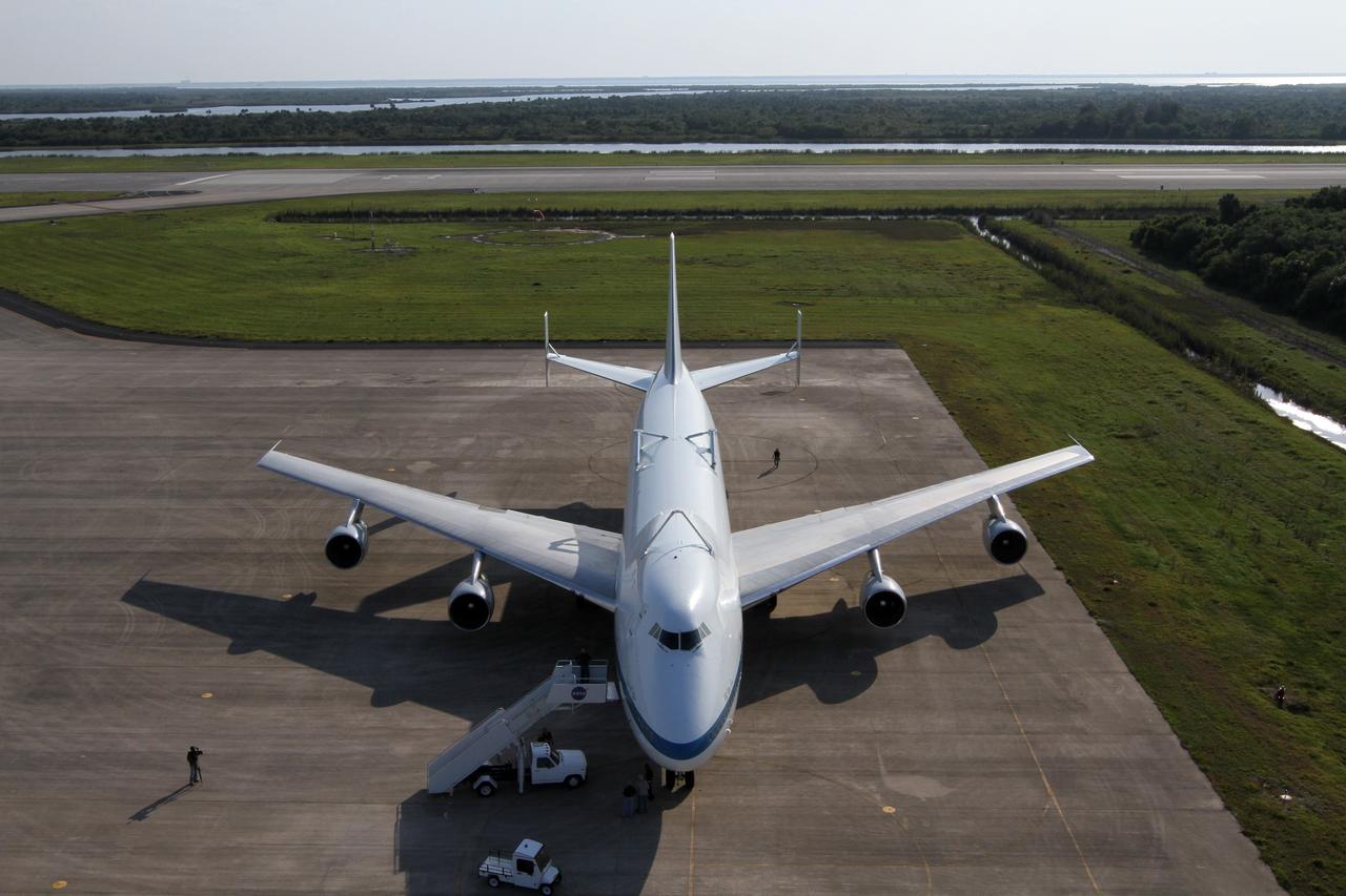 CAPE CANAVERAL, Fla. – This overhead view shows Shuttle Carrier Aircraft parked on the apron of the runway at the Shuttle Landing Facility at NASA’s Kennedy Space Center in Florida.    The aircraft, known as an SCA, arrived at 5:35 p.m. EDT to prepare for shuttle Discovery’s ferry flight to the Washington Dulles International Airport in Sterling, Va., on April 17. This SCA, designated NASA 905, is a modified Boeing 747 jet airliner, originally manufactured for commercial use. One of two SCAs employed over the course of the Space Shuttle Program, NASA 905 is assigned to the remaining ferry missions, delivering the shuttles to their permanent public display sites.  NASA 911 was decommissioned at the NASA Dryden Flight Research Center in California in February. Discovery will be placed on permanent public display in the Smithsonian's National Air and Space Museum Steven F. Udvar-Hazy Center in Chantilly, Va.  For more information on the SCA, visit http://www.nasa.gov/centers/dryden/news/FactSheets/FS-013-DFRC.html. For more information on shuttle transition and retirement activities, visit http://www.nasa.gov/shuttle. Photo credit: NASA/Kim Shiflett