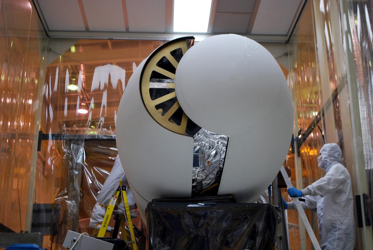 VANDENBERG AIR FORCE BASE, Calif. – The Pegasus payload fairing opens during operations to remove the fairing from around NASA’s Nuclear Spectroscopic Telescope Array, or NuSTAR, in Orbital Sciences’ hangar on Vandenberg Air Force Base in California.    Access to the spacecraft is needed for compatibility testing to verify communication with a tracking station in Hawaii. With the change in the launch timeframe to June, this station will be needed to support launch. After processing of Orbital’s Pegasus XL rocket and the spacecraft are complete, they will be flown on Orbital's L-1011 carrier aircraft from Vandenberg to the Ronald Reagan Ballistic Missile Defense Test Site on the Pacific Ocean’s Kwajalein Atoll for launch.  The high-energy X-ray telescope will conduct a census of black holes, map radioactive material in young supernovae remnants, and study the origins of cosmic rays and the extreme physics around collapsed stars. For more information, visit http://www.nasa.gov/nustar.  Photo credit: NASA/Randy Beaudoin, VAFB