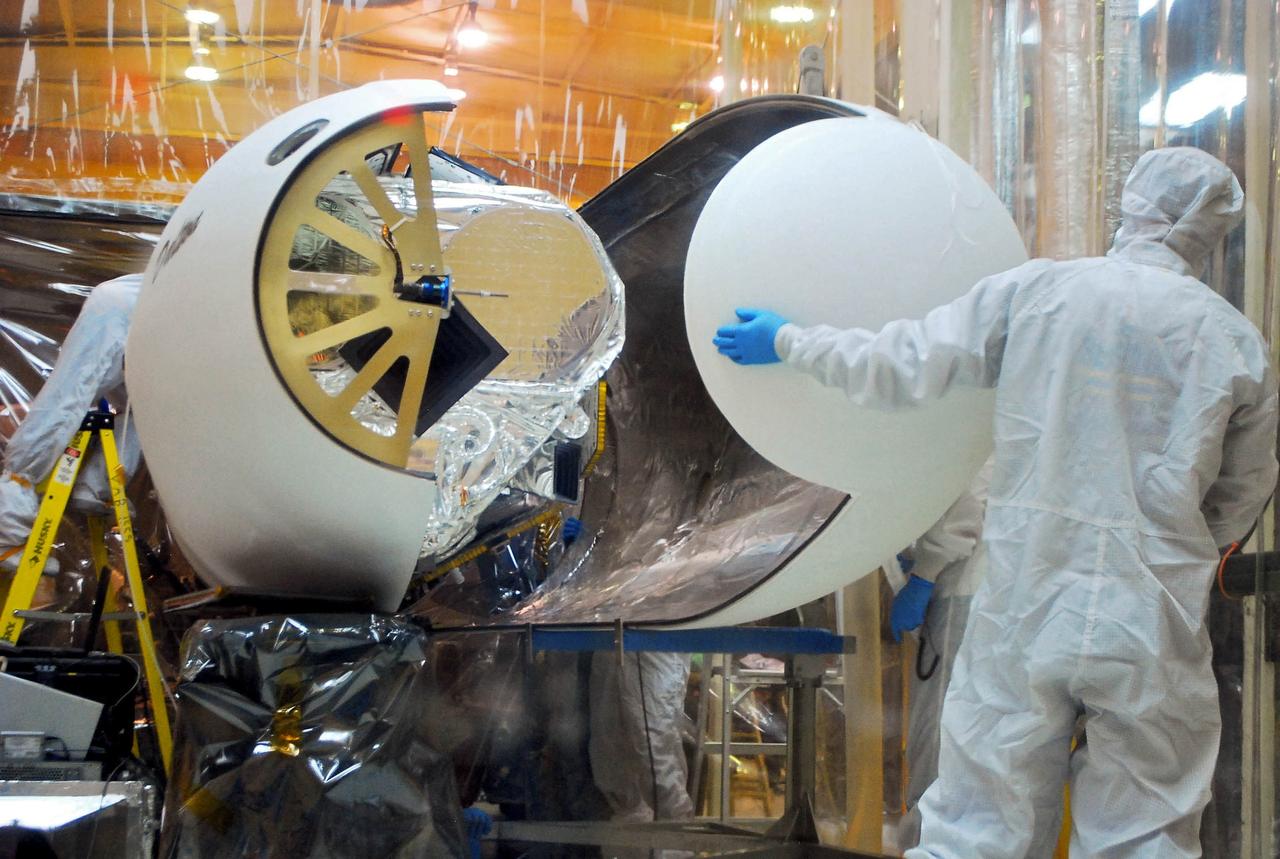 VANDENBERG AIR FORCE BASE, Calif. – An Orbital Sciences’ spacecraft technician monitors the Pegasus payload fairing as it is rotated from around NASA’s Nuclear Spectroscopic Telescope Array, or NuSTAR, in Orbital’s hangar on Vandenberg Air Force Base in California.    Access to the spacecraft is needed for compatibility testing to verify communication with a tracking station in Hawaii. With the change in the launch timeframe to June, this station will be needed to support launch. After processing of Orbital’s Pegasus XL rocket and the spacecraft are complete, they will be flown on Orbital's L-1011 carrier aircraft from Vandenberg to the Ronald Reagan Ballistic Missile Defense Test Site on the Pacific Ocean’s Kwajalein Atoll for launch.  The high-energy X-ray telescope will conduct a census of black holes, map radioactive material in young supernovae remnants, and study the origins of cosmic rays and the extreme physics around collapsed stars. For more information, visit http://www.nasa.gov/nustar.  Photo credit: NASA/Randy Beaudoin, VAFB