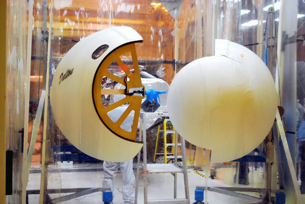 VANDENBERG AIR FORCE BASE, Calif. – Orbital Sciences’ Pegasus XL rocket, in the background, rests outside the environmental enclosure in Orbital’s hangar on Vandenberg Air Force Base in California.  Inside the enclosure, half of the Pegasus fairing has been removed from around NASA’s Nuclear Spectroscopic Telescope Array, or NuSTAR.    Access to the spacecraft is needed for compatibility testing to verify communication with a tracking station in Hawaii. With the change in the launch timeframe to June, this station will be needed to support launch. After processing of Orbital’s Pegasus XL rocket and the spacecraft are complete, they will be flown on Orbital's L-1011 carrier aircraft from Vandenberg to the Ronald Reagan Ballistic Missile Defense Test Site on the Pacific Ocean’s Kwajalein Atoll for launch.  The high-energy X-ray telescope will conduct a census of black holes, map radioactive material in young supernovae remnants, and study the origins of cosmic rays and the extreme physics around collapsed stars. For more information, visit http://www.nasa.gov/nustar.  Photo credit: NASA/Randy Beaudoin, VAFB