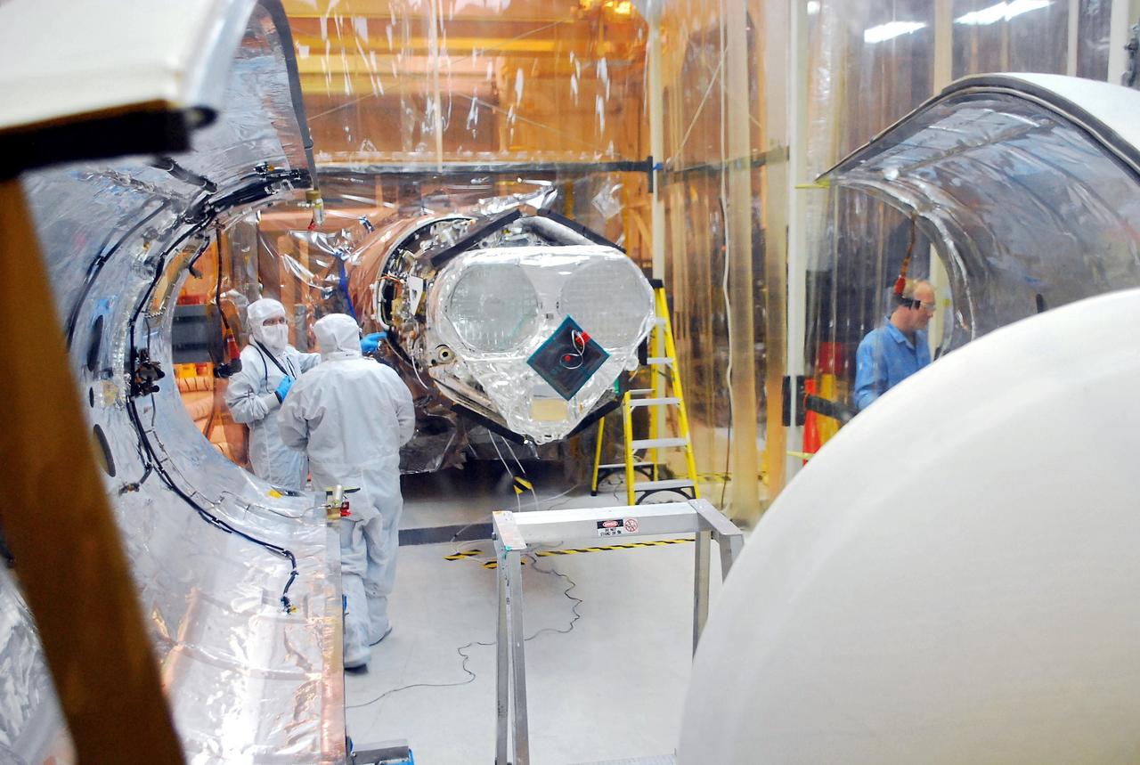 VANDENBERG AIR FORCE BASE, Calif. – Orbital Sciences’ Pegasus XL rocket is viewed over the Pegasus payload fairing, positioned part in and part out of the environmental enclosure in Orbital’s hangar on Vandenberg Air Force Base in California.  Half of the Pegasus fairing has been removed from around NASA’s Nuclear Spectroscopic Telescope Array, or NuSTAR.    Access to the spacecraft is needed for compatibility testing to verify communication with a tracking station in Hawaii. With the change in the launch timeframe to June, this station will be needed to support launch. After processing of Orbital’s Pegasus XL rocket and the spacecraft are complete, they will be flown on Orbital's L-1011 carrier aircraft from Vandenberg to the Ronald Reagan Ballistic Missile Defense Test Site on the Pacific Ocean’s Kwajalein Atoll for launch.  The high-energy X-ray telescope will conduct a census of black holes, map radioactive material in young supernovae remnants, and study the origins of cosmic rays and the extreme physics around collapsed stars. For more information, visit http://www.nasa.gov/nustar.  Photo credit: NASA/Randy Beaudoin, VAFB