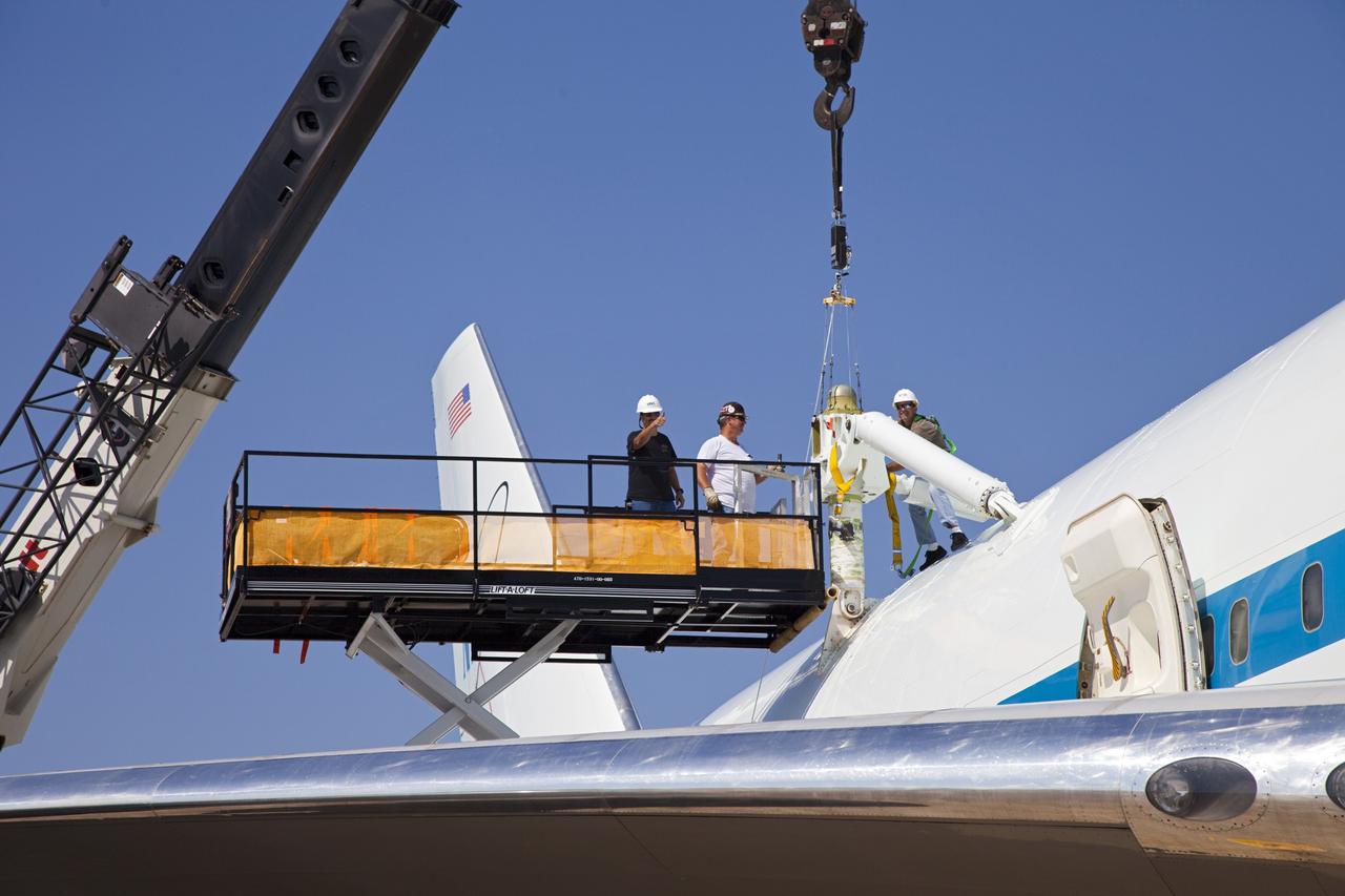 CAPE CANAVERAL, Fla. – At the Shuttle Landing Facility at NASA’s Kennedy Space Center in Florida, maintenance technicians from NASA’s Dryden Flight Research Center in California check attach points on top of NASA’s Shuttle Carrier Aircraft modified 747 jet, or SCA, after arriving from Edwards Air Force Base in California.      During the Space Shuttle Program’s transition and retirement processing, Discovery was prepared for display at Smithsonian’s National Air and Space Museum, Steven F. Udvar-Hazy Center in Chantilly, Va. Discovery is scheduled to be transported atop the SCA, designated NASA 905, to Dulles International Airport in Virginia on April 17 and then moved to the Smithsonian for permanent public display on April 19. The SCA is assigned to the remaining ferry missions, delivering the shuttles to their permanent public display sites. For more information, visit http://www.nasa.gov/shuttle.  Photo credit: NASA/Frankie Martin