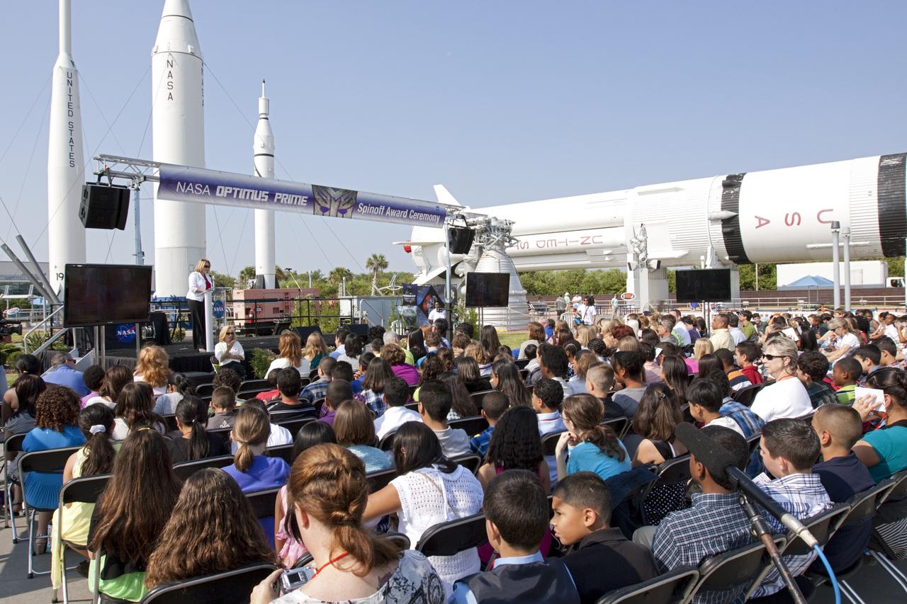 CAPE CANAVERAL, Fla. - Cheryl Hurst, NASA Kennedy Space Center's director of External Relations and Education, addresses students and teachers involved with the NASA OPTIMUS PRIME Spinoff Video Contest in the Rocket Garden of the Kennedy Space Center Visitor Complex. The contest challenged students in grades three through 12 to study NASA spinoff technologies and produce short, creative videos promoting their favorites. The NASA Goddard Space Flight Center's Innovative Partnerships Office in Greenbelt, Md., designed the contest to help students see the benefits of NASA technology here on Earth. NASA collaborated with Hasbro in using the OPTIMUS PRIME character. Photo credit: NASA/Jim Grossmann