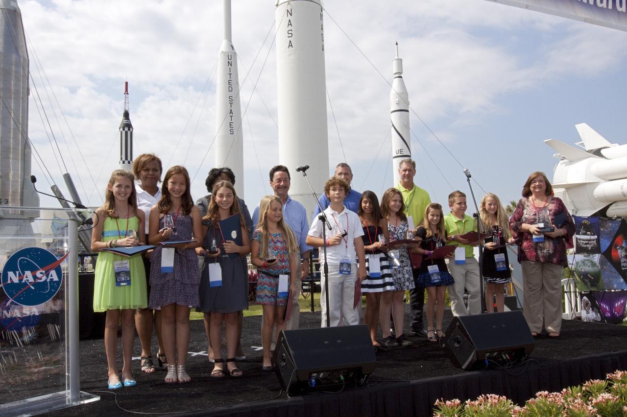 CAPE CANAVERAL, Fla. - Winners of the NASA OPTIMUS PRIME Spinoff Video Contest gather with their awards in the Rocket Garden of the Kennedy Space Center Visitor Complex. The contest challenged students in grades three through 12 to study NASA spinoff technologies and produce short, creative videos promoting their favorites. The NASA Goddard Space Flight Center's Innovative Partnerships Office in Greenbelt, Md., designed the contest to help students see the benefits of NASA technology here on Earth. NASA collaborated with Hasbro in using the OPTIMUS PRIME character. Photo credit: NASA/Jim Grossmann