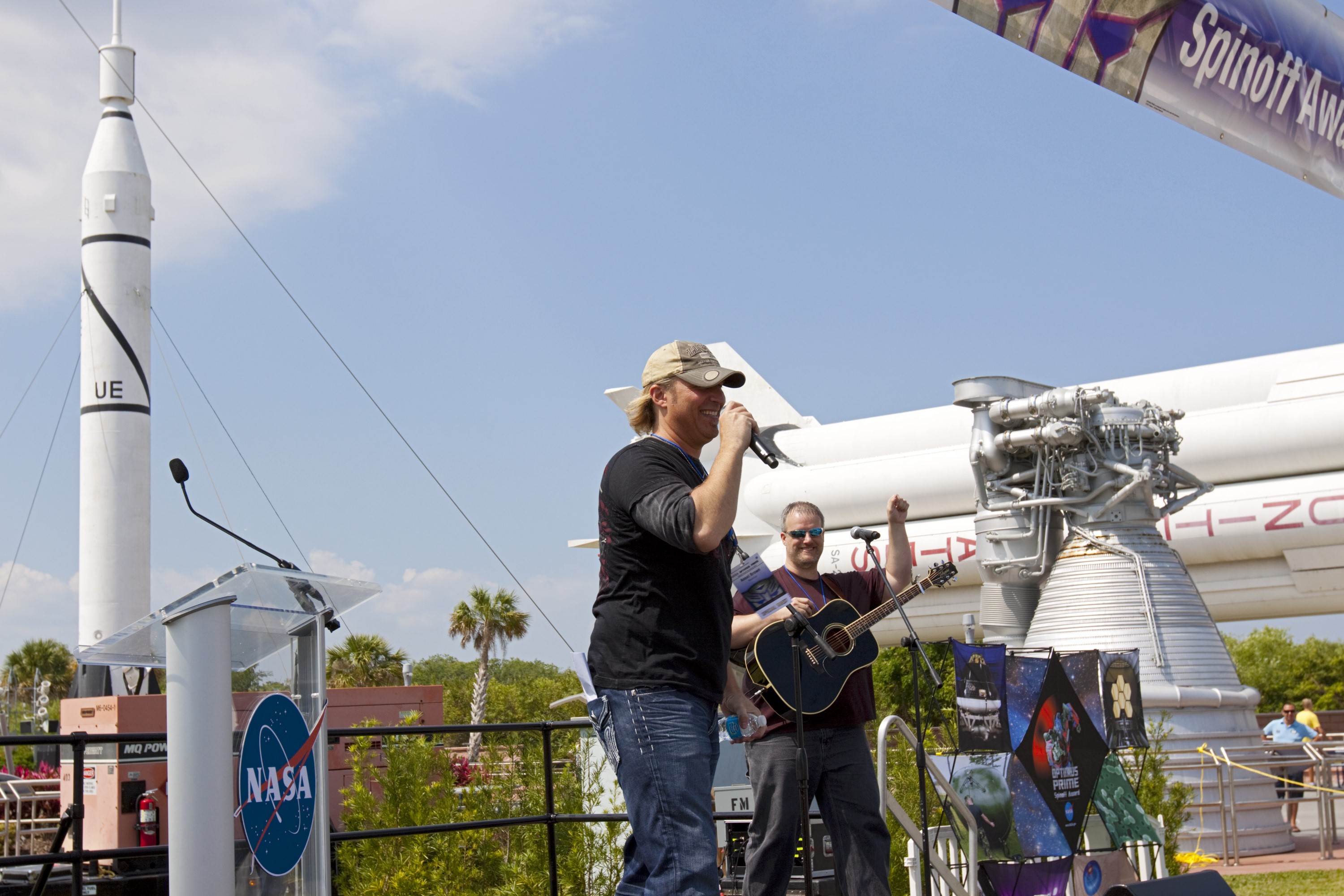 CAPE CANAVERAL, Fla. - Country music singer, Ansel Brown, performs his song "When You Fly" for students and teachers involved with the NASA OPTIMUS PRIME Spinoff Video Contest in the Rocket Garden of the Kennedy Space Center Visitor Complex. The contest challenged students in grades three through 12 to study NASA spinoff technologies and produce short, creative videos promoting their favorites. The NASA Goddard Space Flight Center's Innovative Partnerships Office in Greenbelt, Md., designed the contest to help students see the benefits of NASA technology here on Earth. NASA collaborated with Hasbro in using the OPTIMUS PRIME character. Photo credit: NASA/Jim Grossmann