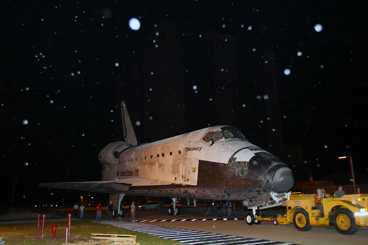 CAPE CANAVERAL, Fla. – Rain falls on space shuttle Discovery as it departs from NASA Kennedy Space Center’s Launch Complex 39 area for the final time.    Discovery is on its way from the Vehicle Assembly Building’s high bay 4 to the Shuttle Landing Facility, or SLF.  At the SLF, Discovery will be hoisted onto a Shuttle Carrier Aircraft, or SCA, with the aid of a mate-demate device.  The SCA, a modified Boeing 747 jet airliner, is scheduled to ferry Discovery to the Washington Dulles International Airport in Virginia on April 17, after which the shuttle will be placed on permanent public display in the Smithsonian's National Air and Space Museum Steven F. Udvar-Hazy Center.  For more information on shuttle transition and retirement activities, visit http://www.nasa.gov/transition. Photo credit: NASA/Kim Shiflett