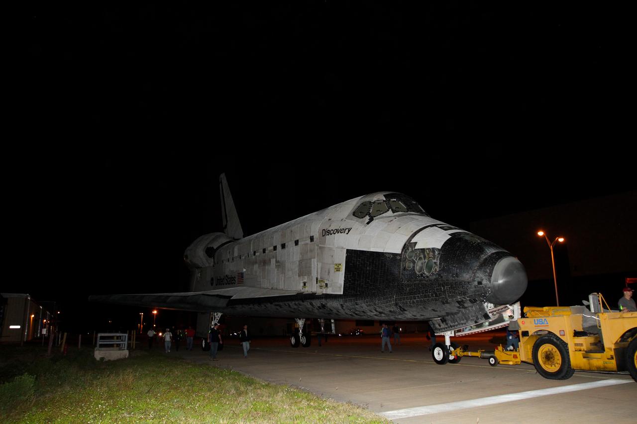 CAPE CANAVERAL, Fla. – Space shuttle Discovery makes its way from the Launch Complex 39 area to the Shuttle Landing Facility or SLF, at NASA’s Kennedy Space Center in Florida.     At the SLF, Discovery will be hoisted onto a Shuttle Carrier Aircraft, or SCA, with the aid of a mate-demate device.  The SCA, a modified Boeing 747 jet airliner, is scheduled to ferry Discovery to the Washington Dulles International Airport in Virginia on April 17, after which the shuttle will be placed on permanent public display in the Smithsonian's National Air and Space Museum Steven F. Udvar-Hazy Center.  For more information on shuttle transition and retirement activities, visit http://www.nasa.gov/transition. Photo credit: NASA/Kim Shiflett