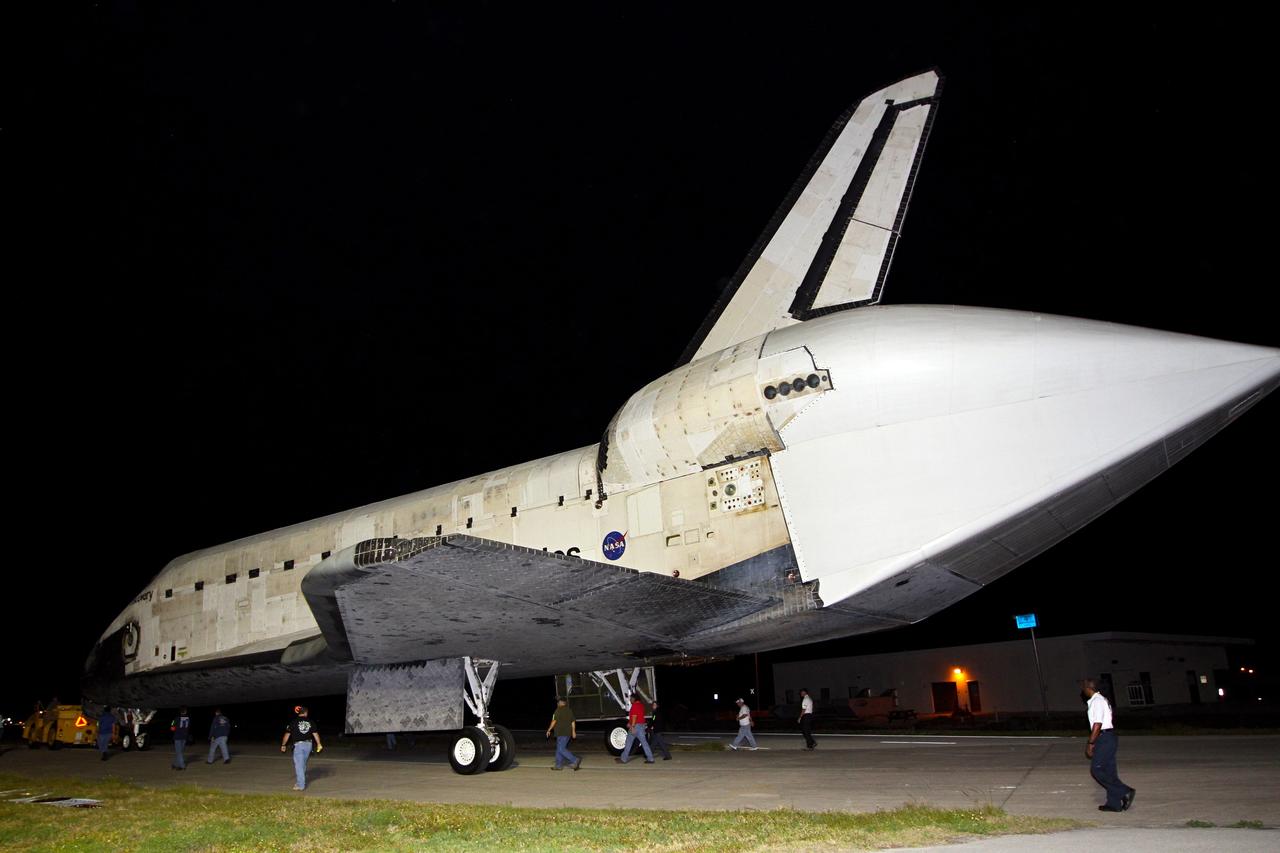 CAPE CANAVERAL, Fla. – A team of aerospace technicians accompanies space shuttle Discovery as it is towed for the final time from the Launch Complex 39 area to the Shuttle Landing Facility or SLF, at NASA’s Kennedy Space Center in Florida. A tail cone has been installed over Discovery’s three replica shuttle main engines to reduce aerodynamic drag and turbulence during its upcoming ferry flight. At the SLF, Discovery will be hoisted onto a Shuttle Carrier Aircraft, or SCA, with the aid of a mate-demate device. The SCA, a modified Boeing 747 jet airliner, is scheduled to ferry Discovery to the Washington Dulles International Airport in Virginia on April 17, after which the shuttle will be placed on permanent public display in the Smithsonian's National Air and Space Museum Steven F. Udvar-Hazy Center. For more information on shuttle transition and retirement activities, visit http://www.nasa.gov/transition. Photo credit: NASA/Kim Shiflett