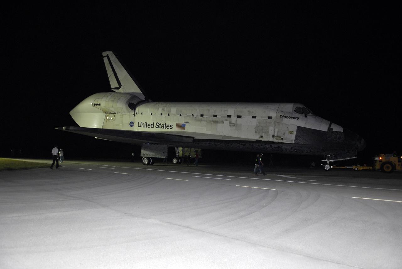 CAPE CANAVERAL, Fla. – Space shuttle Discovery is towed along the access road to the Shuttle Landing Facility, or SLF, at NASA’s Kennedy Space Center in Florida. A tail cone has been installed over its three replica shuttle main engines to reduce aerodynamic drag and turbulence during its upcoming ferry flight.    At the SLF, Discovery will be hoisted onto a Shuttle Carrier Aircraft, or SCA, with the aid of a mate-demate device.  The SCA, a modified Boeing 747 jet airliner, is scheduled to ferry Discovery to the Washington Dulles International Airport in Virginia on April 17, after which the shuttle will be placed on permanent public display in the Smithsonian's National Air and Space Museum Steven F. Udvar-Hazy Center.  For more information on shuttle transition and retirement activities, visit http://www.nasa.gov/transition. Photo credit: NASA/Tim Jacobs