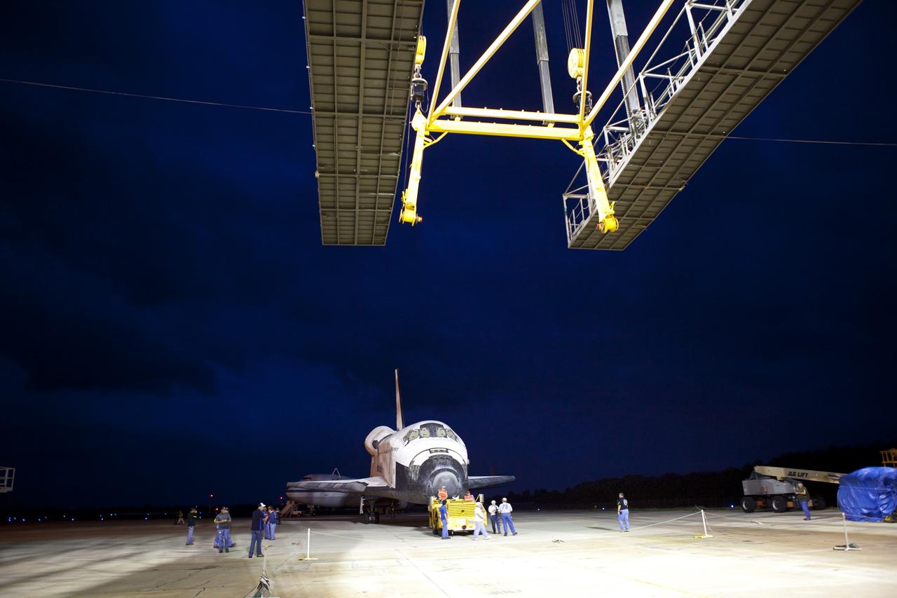 CAPE CANAVERAL, Fla. – Space shuttle Discovery is towed into position beside the mate-demate device, or MDD, at the Shuttle Landing Facility at NASA’s Kennedy Space Center in Florida. The MDD is a large gantry-like steel structure used to hoist a shuttle off the ground and position it onto the back of a Shuttle Carrier Aircraft, or SCA. The SCA is a Boeing 747 jet, originally manufactured for commercial use, which was modified by NASA to transport the shuttles between destinations on Earth. The SCA designated NASA 905 is assigned to the remaining ferry missions, delivering the shuttles to their permanent public display sites. Discovery’s new home will be the Smithsonian's National Air and Space Museum Steven F. Udvar-Hazy Center in Chantilly, Va. For more information on the SCA, visit http://www.nasa.gov/centers/dryden/news/FactSheets/FS-013-DFRC.html. For more information on shuttle transition and retirement activities, visit http://www.nasa.gov/transition. Photo credit: NASA/Dimitri Gerondidakis