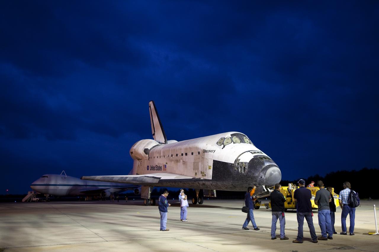 CAPE CANAVERAL, Fla. – Preparations are under way to lift space shuttle Discovery onto the back of the Shuttle Carrier Aircraft, or SCA, behind it at the Shuttle Landing Facility, or SLF, at NASA’s Kennedy Space Center in Florida. This SCA, designated NASA 905, is a Boeing 747 jet originally manufactured for commercial use, which was modified by NASA to transport the shuttles between destinations on Earth. NASA 905 is assigned to the remaining ferry missions, delivering the shuttles to their permanent public display sites. Discovery’s new home will be the Smithsonian's National Air and Space Museum Steven F. Udvar-Hazy Center in Chantilly, Va. For more information on the SCA, visit http://www.nasa.gov/centers/dryden/news/FactSheets/FS-013-DFRC.html. For more information on shuttle transition and retirement activities, visit http://www.nasa.gov/transition. Photo credit: NASA/Dimitri Gerondidakis