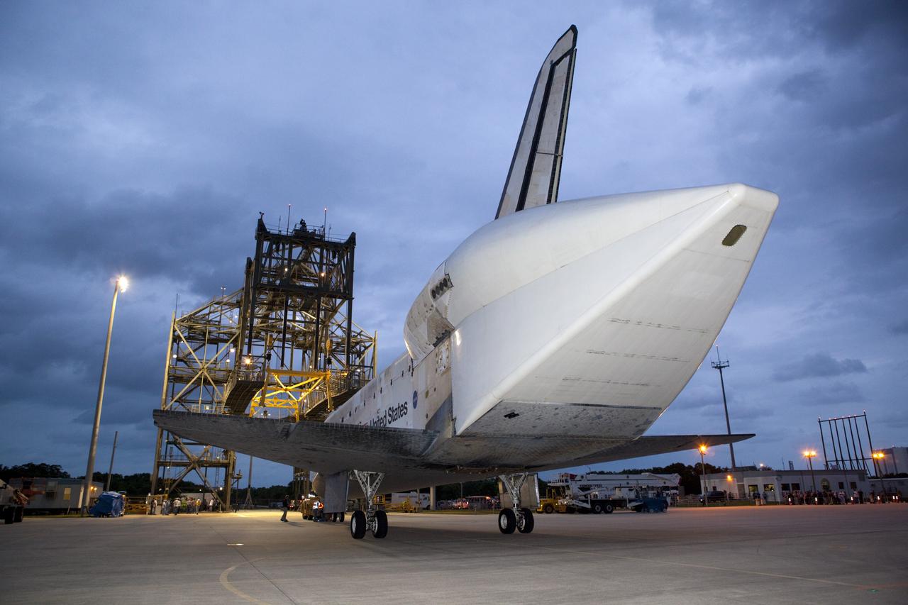 CAPE CANAVERAL, Fla. – Space shuttle Discovery rolls into position beside the mate-demate device, or MDD, at the Shuttle Landing Facility, or SLF, at NASA’s Kennedy Space Center in Florida. A tail cone has been installed over its three replica shuttle main engines to reduce aerodynamic drag and turbulence during its upcoming ferry flight.    The MDD is a large gantry-like steel structure used to hoist a shuttle off the ground and position it onto the back of a Shuttle Carrier Aircraft, or SCA. The SCA is a Boeing 747 jet, originally manufactured for commercial use, which was modified by NASA to transport the shuttles between destinations on Earth.  The SCA designated NASA 905 is assigned to the remaining ferry missions, delivering the shuttles to their permanent public display sites.  Discovery’s new home will be the Smithsonian's National Air and Space Museum Steven F. Udvar-Hazy Center in Chantilly, Va.  For more information on the SCA, visit http://www.nasa.gov/centers/dryden/news/FactSheets/FS-013-DFRC.html. For more information on shuttle transition and retirement activities, visit http://www.nasa.gov/transition. Photo credit: NASA/Dimitri Gerondidakis