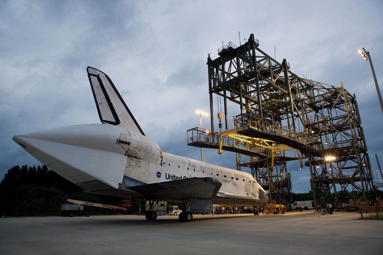 CAPE CANAVERAL, Fla. – Space shuttle Discovery rolls into position beside the mate-demate device, or MDD, at the Shuttle Landing Facility, or SLF, at NASA’s Kennedy Space Center in Florida. A tail cone has been installed over its three replica shuttle main engines to reduce aerodynamic drag and turbulence during its upcoming ferry flight.    The MDD is a large gantry-like steel structure used to hoist a shuttle off the ground and position it onto the back of a Shuttle Carrier Aircraft, or SCA. The SCA is a Boeing 747 jet, originally manufactured for commercial use, which was modified by NASA to transport the shuttles between destinations on Earth.  The SCA designated NASA 905 is assigned to the remaining ferry missions, delivering the shuttles to their permanent public display sites.  Discovery’s new home will be the Smithsonian's National Air and Space Museum Steven F. Udvar-Hazy Center in Chantilly, Va.  For more information on the SCA, visit http://www.nasa.gov/centers/dryden/news/FactSheets/FS-013-DFRC.html. For more information on shuttle transition and retirement activities, visit http://www.nasa.gov/transition. Photo credit: NASA/Dimitri Gerondidakis