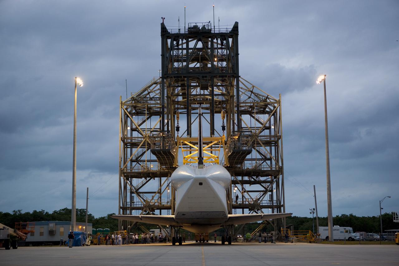 CAPE CANAVERAL, Fla. – Space shuttle Discovery rolls into position beneath the mate-demate device, or MDD, at the Shuttle Landing Facility, or SLF, at NASA’s Kennedy Space Center in Florida. A tail cone has been installed over its three replica shuttle main engines to reduce aerodynamic drag and turbulence during its upcoming ferry flight. The MDD is a large gantry-like steel structure used to hoist a shuttle off the ground and position it onto the back of a Shuttle Carrier Aircraft, or SCA. The SCA is a Boeing 747 jet, originally manufactured for commercial use, which was modified by NASA to transport the shuttles between destinations on Earth. The SCA designated NASA 905 is assigned to the remaining ferry missions, delivering the shuttles to their permanent public display sites. Discovery’s new home will be the Smithsonian's National Air and Space Museum Steven F. Udvar-Hazy Center in Chantilly, Va. For more information on the SCA, visit http://www.nasa.gov/centers/dryden/news/FactSheets/FS-013-DFRC.html. For more information on shuttle transition and retirement activities, visit http://www.nasa.gov/transition. Photo credit: NASA/Dimitri Gerondidakis