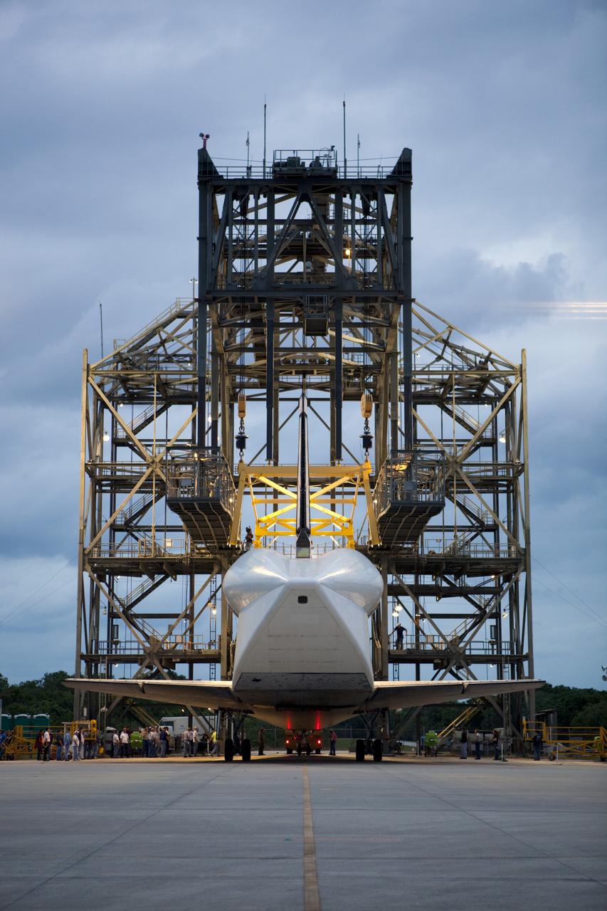 CAPE CANAVERAL, Fla. – Space shuttle Discovery rolls into position beneath the mate-demate device, or MDD, at the Shuttle Landing Facility, or SLF, at NASA’s Kennedy Space Center in Florida. A tail cone has been installed over its three replica shuttle main engines to reduce aerodynamic drag and turbulence during its upcoming ferry flight. The MDD is a large gantry-like steel structure used to hoist a shuttle off the ground and position it onto the back of a Shuttle Carrier Aircraft, or SCA. The SCA is a Boeing 747 jet, originally manufactured for commercial use, which was modified by NASA to transport the shuttles between destinations on Earth. The SCA designated NASA 905 is assigned to the remaining ferry missions, delivering the shuttles to their permanent public display sites. Discovery’s new home will be the Smithsonian's National Air and Space Museum Steven F. Udvar-Hazy Center in Chantilly, Va. For more information on the SCA, visit http://www.nasa.gov/centers/dryden/news/FactSheets/FS-013-DFRC.html. For more information on shuttle transition and retirement activities, visit http://www.nasa.gov/transition. Photo credit: NASA/Dimitri Gerondidakis
