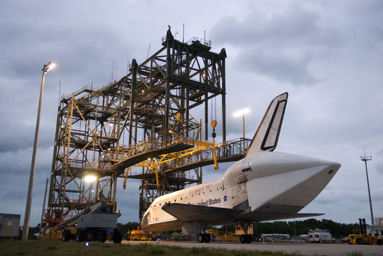 CAPE CANAVERAL, Fla. – Space shuttle Discovery rolls into position beneath the mate-demate device, or MDD, at the Shuttle Landing Facility at NASA’s Kennedy Space Center in Florida. The MDD is a large gantry-like steel structure used to hoist a shuttle off the ground and position it onto the back of a Shuttle Carrier Aircraft, or SCA. The SCA is a Boeing 747 jet, originally manufactured for commercial use, which was modified by NASA to transport the shuttles between destinations on Earth. The SCA designated NASA 905 is assigned to the remaining ferry missions, delivering the shuttles to their permanent public display sites. Discovery’s new home will be the Smithsonian's National Air and Space Museum Steven F. Udvar-Hazy Center in Chantilly, Va. For more information on the SCA, visit http://www.nasa.gov/centers/dryden/news/FactSheets/FS-013-DFRC.html. For more information on shuttle transition and retirement activities, visit http://www.nasa.gov/transition. Photo credit: NASA/Tim Jacobs