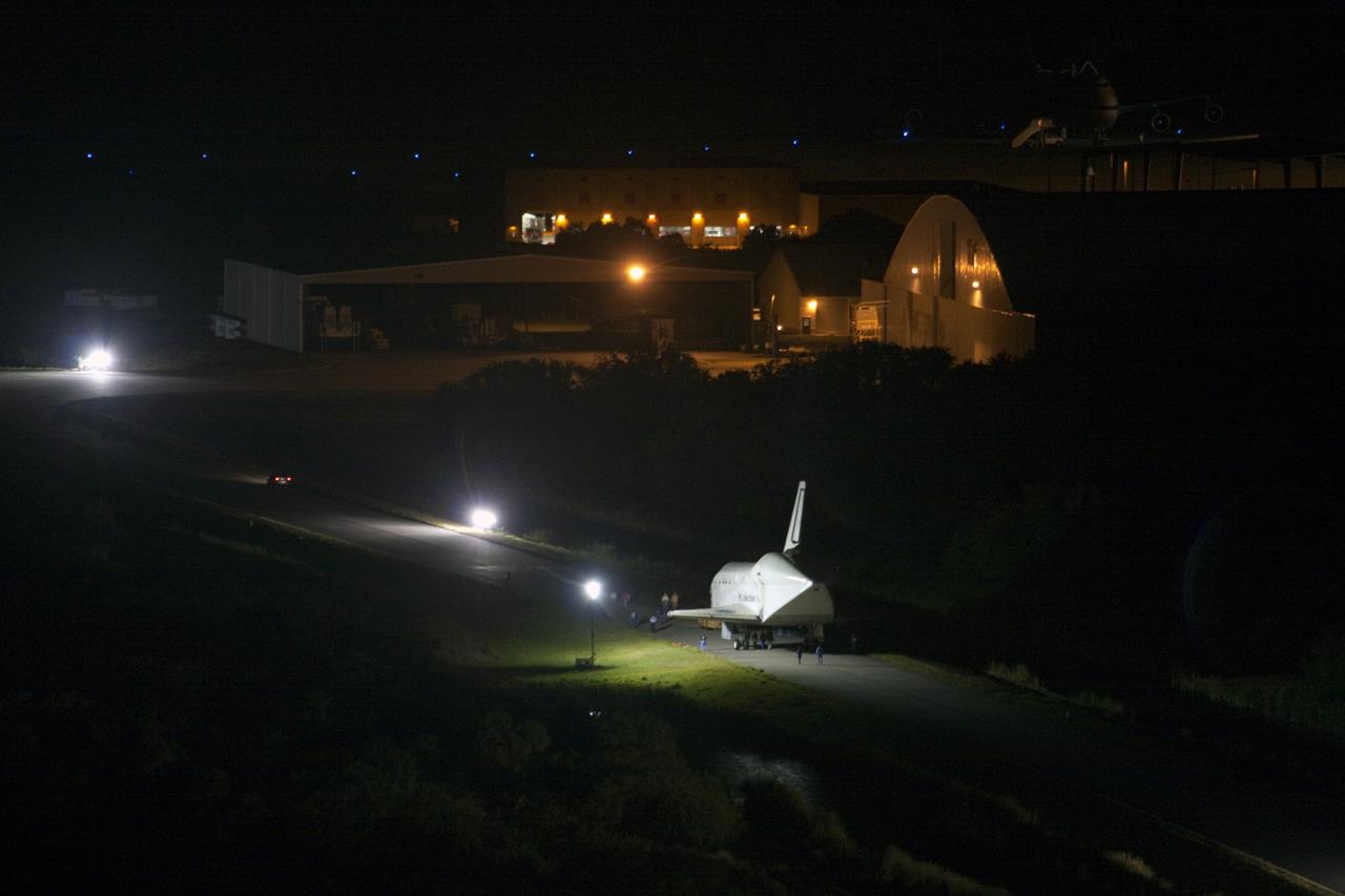 CAPE CANAVERAL, Fla. – At NASA’s Kennedy Space Center in Florida, space shuttle Discovery makes its way along the access road past the hangar at the Shuttle Landing Facility, or SLF, in darkness.  Its move got under way at 5 a.m. EDT.    At the SLF, Discovery will be hoisted onto a Shuttle Carrier Aircraft, or SCA, with the aid of a mate-demate device.  The SCA, a modified Boeing 747 jet airliner, is scheduled to ferry Discovery to the Washington Dulles International Airport in Virginia on April 17, after which the shuttle will be placed on permanent public display in the Smithsonian's National Air and Space Museum Steven F. Udvar-Hazy Center.  For more information on shuttle transition and retirement activities, visit http://www.nasa.gov/transition. Photo credit: NASA/Jim Grossmann