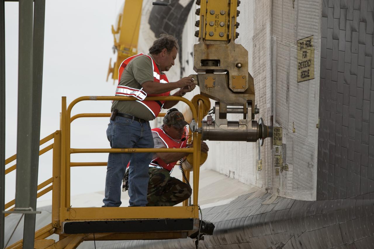 CAPE CANAVERAL, Fla. – At the Shuttle Landing Facility at NASA’s Kennedy Space Center in Florida, workers secure a sling to space shuttle Discovery to enable the mate-demate device to lift it onto a Shuttle Carrier Aircraft. The device, known as the MDD, is a large gantry-like steel structure used to hoist a shuttle off the ground and position it onto the back of the aircraft, or SCA. The SCA is a Boeing 747 jet, originally manufactured for commercial use, which was modified by NASA to transport the shuttles between destinations on Earth. The SCA designated NASA 905 is assigned to the remaining ferry missions, delivering the shuttles to their permanent public display sites. NASA 905 is scheduled to ferry Discovery to the Washington Dulles International Airport in Virginia on April 17, after which the shuttle will be placed on display in the Smithsonian's National Air and Space Museum Steven F. Udvar-Hazy Center. For more information on the SCA, visit http://www.nasa.gov/centers/dryden/news/FactSheets/FS-013-DFRC.html. For more information on shuttle transition and retirement activities, visit http://www.nasa.gov/transition. Photo credit: NASA/Dimitri Gerondidakis
