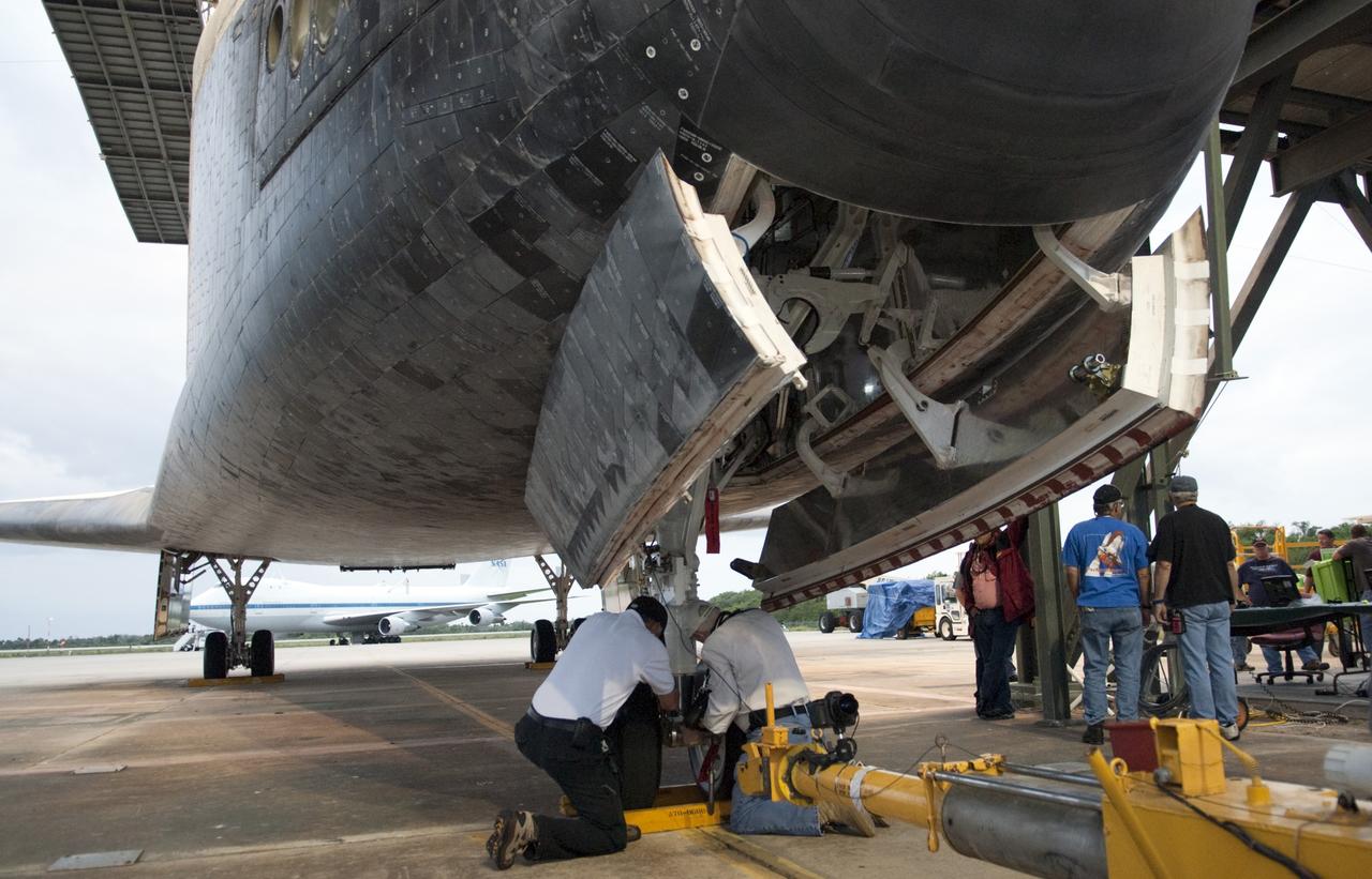 CAPE CANAVERAL, Fla. – At the Shuttle Landing Facility at NASA’s Kennedy Space Center in Florida, workers disconnect the tow vehicle from space shuttle Discovery before it is lifted onto the top of a Shuttle Carrier Aircraft with the aid of the mate-demate device. The device, known as the MDD, is a large gantry-like steel structure used to hoist a shuttle off the ground and position it onto the back of the aircraft, or SCA. The SCA is a Boeing 747 jet, originally manufactured for commercial use, which was modified by NASA to transport the shuttles between destinations on Earth. The SCA designated NASA 905 is assigned to the remaining ferry missions, delivering the shuttles to their permanent public display sites. NASA 905 is scheduled to ferry Discovery to the Washington Dulles International Airport in Virginia on April 17, after which the shuttle will be placed on display in the Smithsonian's National Air and Space Museum Steven F. Udvar-Hazy Center. For more information on the SCA, visit http://www.nasa.gov/centers/dryden/news/FactSheets/FS-013-DFRC.html. For more information on shuttle transition and retirement activities, visit http://www.nasa.gov/transition. Photo credit: NASA/Dimitri Gerondidakis