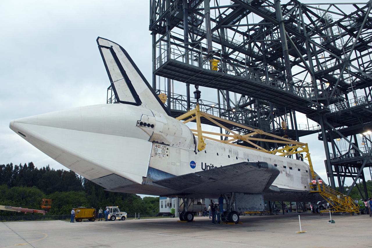 CAPE CANAVERAL, Fla. – At the Shuttle Landing Facility at NASA’s Kennedy Space Center in Florida, a sling is attached to space shuttle Discovery during preparations to lift it onto the top of a Shuttle Carrier Aircraft with the aid of the mate-demate device. The device, known as the MDD, is a large gantry-like steel structure used to hoist a shuttle off the ground and position it onto the back of the aircraft, or SCA. The SCA is a Boeing 747 jet, originally manufactured for commercial use, which was modified by NASA to transport the shuttles between destinations on Earth. The SCA designated NASA 905 is assigned to the remaining ferry missions, delivering the shuttles to their permanent public display sites. NASA 905 is scheduled to ferry Discovery to the Washington Dulles International Airport in Virginia on April 17, after which the shuttle will be placed on display in the Smithsonian's National Air and Space Museum Steven F. Udvar-Hazy Center. For more information on the SCA, visit http://www.nasa.gov/centers/dryden/news/FactSheets/FS-013-DFRC.html. For more information on shuttle transition and retirement activities, visit http://www.nasa.gov/transition. Photo credit: NASA/Dimitri Gerondidakis