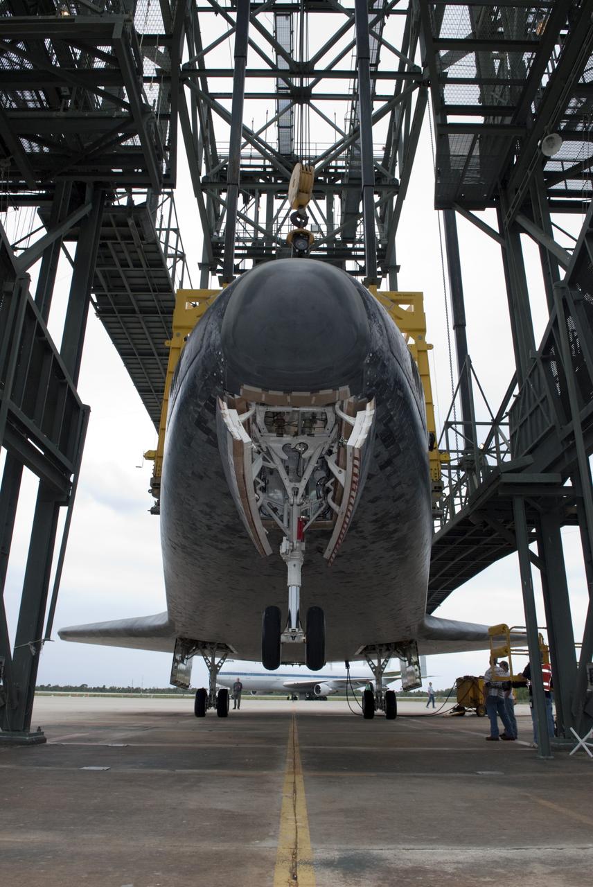 CAPE CANAVERAL, Fla. – At the Shuttle Landing Facility at NASA’s Kennedy Space Center in Florida, a crane lifts space shuttle Discovery off the ground inside the mate-demate device. Operations are under way to position Discovery on top of a Shuttle Carrier Aircraft. The device, known as the MDD, is a large gantry-like steel structure used to hoist a shuttle off the ground and position it onto the back of the aircraft, or SCA. The SCA is a Boeing 747 jet, originally manufactured for commercial use, which was modified by NASA to transport the shuttles between destinations on Earth. The SCA designated NASA 905 is assigned to the remaining ferry missions, delivering the shuttles to their permanent public display sites. NASA 905 is scheduled to ferry Discovery to the Washington Dulles International Airport in Virginia on April 17, after which the shuttle will be placed on display in the Smithsonian's National Air and Space Museum Steven F. Udvar-Hazy Center. For more information on the SCA, visit http://www.nasa.gov/centers/dryden/news/FactSheets/FS-013-DFRC.html. For more information on shuttle transition and retirement activities, visit http://www.nasa.gov/transition. Photo credit: NASA/Dimitri Gerondidakis
