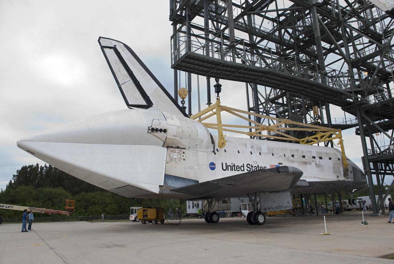 CAPE CANAVERAL, Fla. – At the Shuttle Landing Facility at NASA’s Kennedy Space Center in Florida, space shuttle Discovery hovers above the ground inside the mate-demate device. Operations are under way to position Discovery on top of a Shuttle Carrier Aircraft. The device, known as the MDD, is a large gantry-like steel structure used to hoist a shuttle off the ground and position it onto the back of the aircraft, or SCA. The SCA is a Boeing 747 jet, originally manufactured for commercial use, which was modified by NASA to transport the shuttles between destinations on Earth. The SCA designated NASA 905 is assigned to the remaining ferry missions, delivering the shuttles to their permanent public display sites. NASA 905 is scheduled to ferry Discovery to the Washington Dulles International Airport in Virginia on April 17, after which the shuttle will be placed on display in the Smithsonian's National Air and Space Museum Steven F. Udvar-Hazy Center. For more information on the SCA, visit http://www.nasa.gov/centers/dryden/news/FactSheets/FS-013-DFRC.html. For more information on shuttle transition and retirement activities, visit http://www.nasa.gov/transition. Photo credit: NASA/Dimitri Gerondidakis