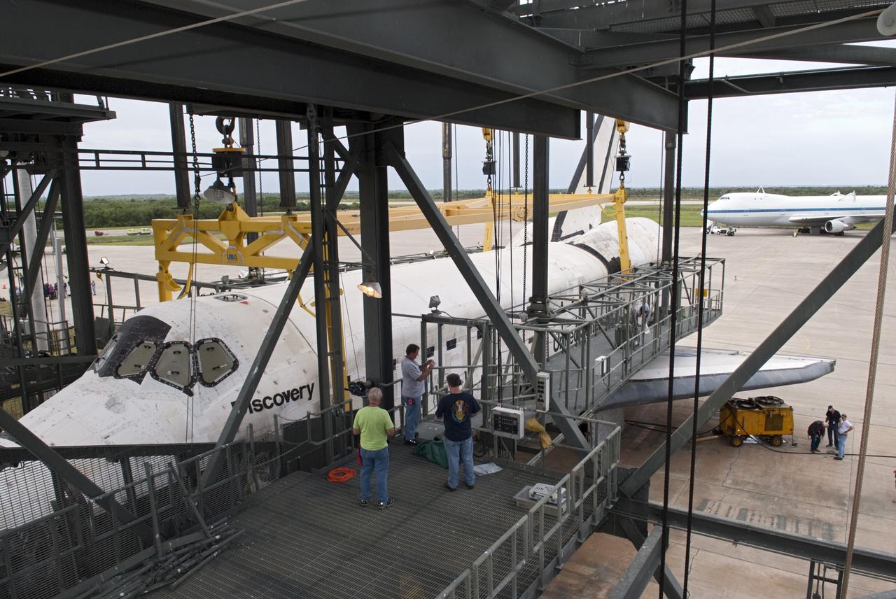 CAPE CANAVERAL, Fla. – At the Shuttle Landing Facility at NASA’s Kennedy Space Center in Florida, operations are under way to lift space shuttle Discovery onto the Shuttle Carrier Aircraft in the background with the aid of the mate-demate device. The device, known as the MDD, is a large gantry-like steel structure used to hoist a shuttle off the ground and position it onto the back of the aircraft, or SCA. The SCA is a Boeing 747 jet, originally manufactured for commercial use, which was modified by NASA to transport the shuttles between destinations on Earth. The SCA designated NASA 905 is assigned to the remaining ferry missions, delivering the shuttles to their permanent public display sites. NASA 905 is scheduled to ferry Discovery to the Washington Dulles International Airport in Virginia on April 17, after which the shuttle will be placed on display in the Smithsonian's National Air and Space Museum Steven F. Udvar-Hazy Center. For more information on the SCA, visit http://www.nasa.gov/centers/dryden/news/FactSheets/FS-013-DFRC.html. For more information on shuttle transition and retirement activities, visit http://www.nasa.gov/transition. Photo credit: NASA/Dimitri Gerondidakis