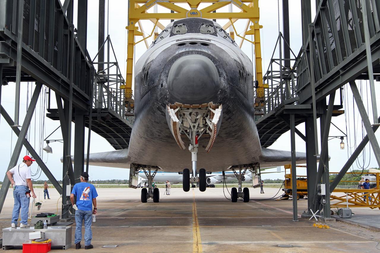 CAPE CANAVERAL, Fla. – At the Shuttle Landing Facility at NASA’s Kennedy Space Center in Florida, space shuttle Discovery’s front wheels hover above the ground inside the mate-demate device. Operations are under way to position Discovery on top of a Shuttle Carrier Aircraft. The device, known as the MDD, is a large gantry-like steel structure used to hoist a shuttle off the ground and position it onto the back of the aircraft, or SCA. The SCA is a Boeing 747 jet, originally manufactured for commercial use, which was modified by NASA to transport the shuttles between destinations on Earth. The SCA designated NASA 905 is assigned to the remaining ferry missions, delivering the shuttles to their permanent public display sites. NASA 905 is scheduled to ferry Discovery to the Washington Dulles International Airport in Virginia on April 17, after which the shuttle will be placed on display in the Smithsonian's National Air and Space Museum Steven F. Udvar-Hazy Center. For more information on the SCA, visit http://www.nasa.gov/centers/dryden/news/FactSheets/FS-013-DFRC.html. For more information on shuttle transition and retirement activities, visit http://www.nasa.gov/transition. Photo credit: NASA/Kim Shiflett