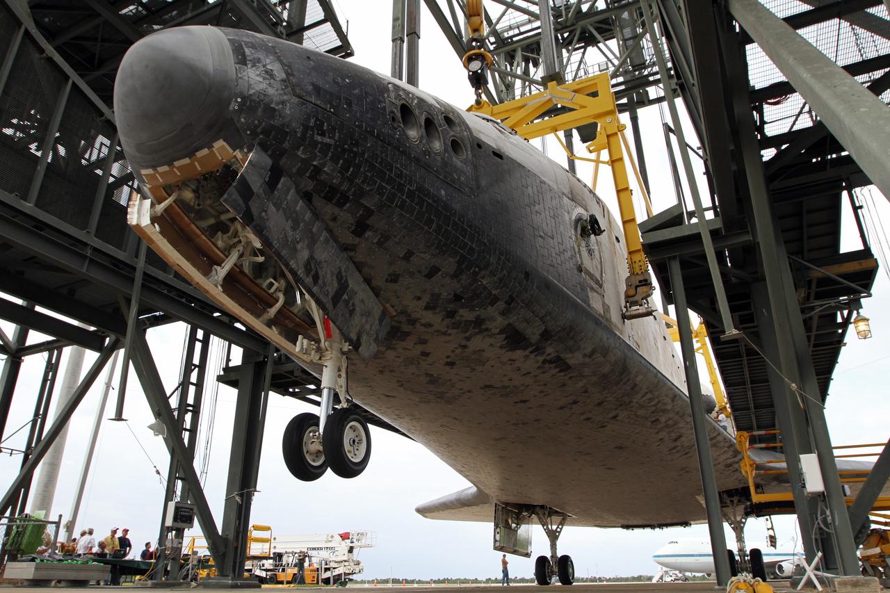 CAPE CANAVERAL, Fla. – At the Shuttle Landing Facility at NASA’s Kennedy Space Center in Florida, operations are under way at the mate-demate device to lift space shuttle Discovery on top of a Shuttle Carrier Aircraft. The device, known as the MDD, is a large gantry-like steel structure used to hoist a shuttle off the ground and position it onto the back of the aircraft, or SCA. The SCA is a Boeing 747 jet, originally manufactured for commercial use, which was modified by NASA to transport the shuttles between destinations on Earth. The SCA designated NASA 905 is assigned to the remaining ferry missions, delivering the shuttles to their permanent public display sites. NASA 905 is scheduled to ferry Discovery to the Washington Dulles International Airport in Virginia on April 17, after which the shuttle will be placed on display in the Smithsonian's National Air and Space Museum Steven F. Udvar-Hazy Center. For more information on the SCA, visit http://www.nasa.gov/centers/dryden/news/FactSheets/FS-013-DFRC.html. For more information on shuttle transition and retirement activities, visit http://www.nasa.gov/transition. Photo credit: NASA/Kim Shiflett