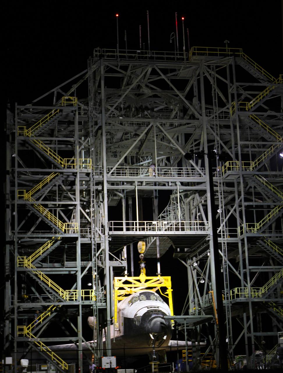 CAPE CANAVERAL, Fla. – Before daybreak at the Shuttle Landing Facility at NASA’s Kennedy Space Center in Florida, preparations are under way at the mate-demate device to resume mating operations of space shuttle Discovery to a Shuttle Carrier Aircraft. The yellow sling was attached to the shuttle yesterday, but out-of-parameter winds required that operations be suspended for the day.    The device, known as the MDD, is a large gantry-like steel structure used to hoist a shuttle off the ground and position it onto the back of the aircraft, or SCA. The SCA is a Boeing 747 jet, originally manufactured for commercial use, which was modified by NASA to transport the shuttles between destinations on Earth. The SCA designated NASA 905 is assigned to the remaining ferry missions, delivering the shuttles to their permanent public display sites.  NASA 905 is scheduled to ferry Discovery to the Washington Dulles International Airport in Virginia on April 17, after which the shuttle will be placed on display in the Smithsonian's National Air and Space Museum Steven F. Udvar-Hazy Center. For more information on the SCA, visit http://www.nasa.gov/centers/dryden/news/FactSheets/FS-013-DFRC.html. For more information on shuttle transition and retirement activities, visit http://www.nasa.gov/transition. Photo credit: NASA/Kim Shiflett