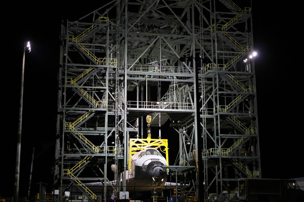 CAPE CANAVERAL, Fla. – Before daybreak at the Shuttle Landing Facility at NASA’s Kennedy Space Center in Florida, preparations are under way at the mate-demate device to resume mating operations of space shuttle Discovery to a Shuttle Carrier Aircraft. The yellow sling was attached to the shuttle yesterday, but out-of-parameter winds required that operations be suspended for the day. The device, known as the MDD, is a large gantry-like steel structure used to hoist a shuttle off the ground and position it onto the back of the aircraft, or SCA. The SCA is a Boeing 747 jet, originally manufactured for commercial use, which was modified by NASA to transport the shuttles between destinations on Earth. The SCA designated NASA 905 is assigned to the remaining ferry missions, delivering the shuttles to their permanent public display sites. NASA 905 is scheduled to ferry Discovery to the Washington Dulles International Airport in Virginia on April 17, after which the shuttle will be placed on display in the Smithsonian's National Air and Space Museum Steven F. Udvar-Hazy Center. For more information on the SCA, visit http://www.nasa.gov/centers/dryden/news/FactSheets/FS-013-DFRC.html. For more information on shuttle transition and retirement activities, visit http://www.nasa.gov/transition. Photo credit: NASA/Kim Shiflett