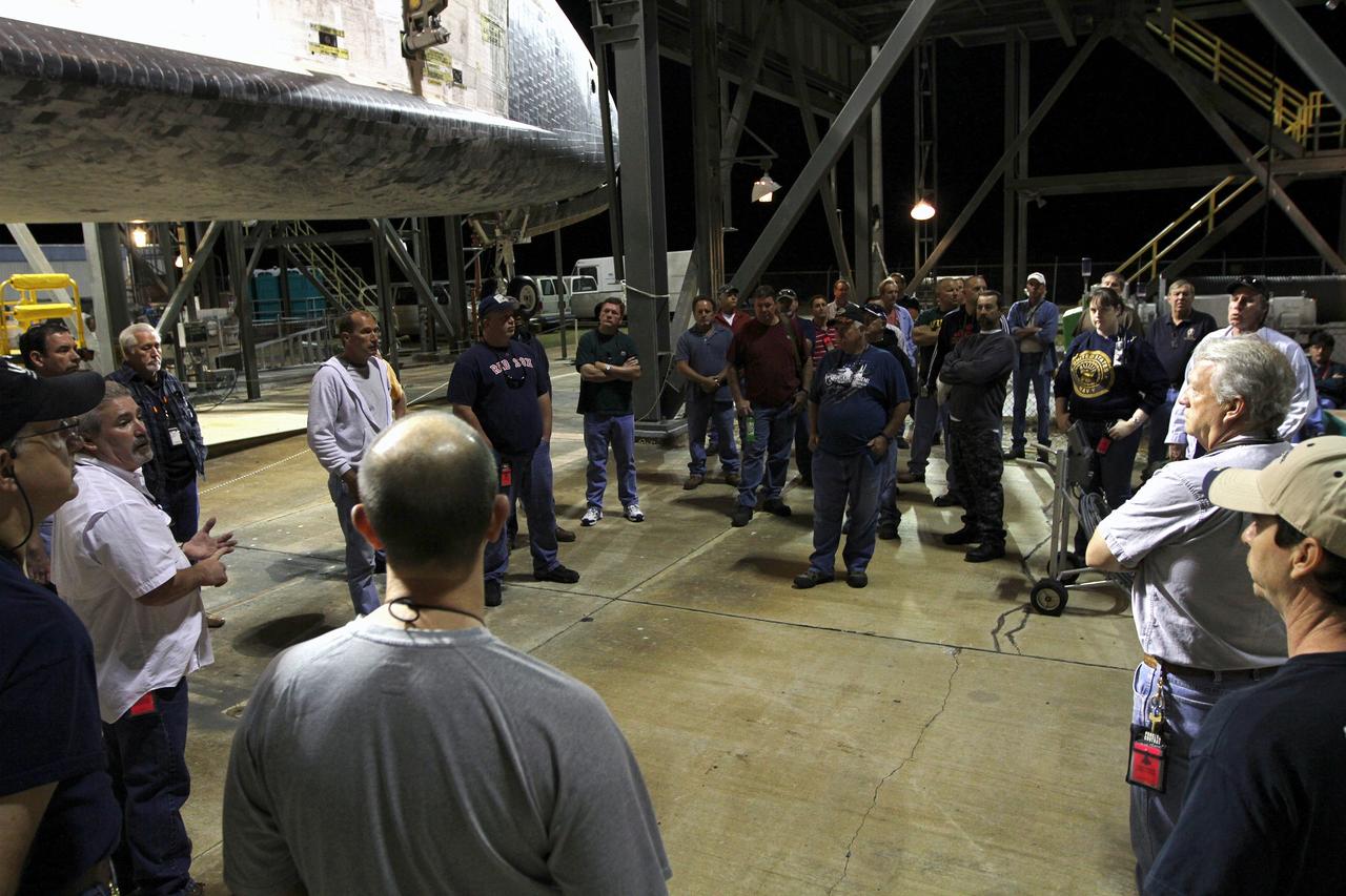CAPE CANAVERAL, Fla. – Before daybreak at the Shuttle Landing Facility at NASA’s Kennedy Space Center in Florida, the team responsible for the handling of space shuttle Discovery receives a briefing at the mate-demate device. Discovery was moved from the Vehicle Assembly Building yesterday, but out-of-parameter winds at the landing facility required that operations to lift it onto a Shuttle Carrier Aircraft be suspended for the day.    The device, known as the MDD, is a large gantry-like steel structure used to hoist a shuttle off the ground and position it onto the back of the aircraft, or SCA. The SCA is a Boeing 747 jet, originally manufactured for commercial use, which was modified by NASA to transport the shuttles between destinations on Earth. The SCA designated NASA 905 is assigned to the remaining ferry missions, delivering the shuttles to their permanent public display sites.  NASA 905 is scheduled to ferry Discovery to the Washington Dulles International Airport in Virginia on April 17, after which the shuttle will be placed on display in the Smithsonian's National Air and Space Museum Steven F. Udvar-Hazy Center. For more information on the SCA, visit http://www.nasa.gov/centers/dryden/news/FactSheets/FS-013-DFRC.html. For more information on shuttle transition and retirement activities, visit http://www.nasa.gov/transition. Photo credit: NASA/Kim Shiflett