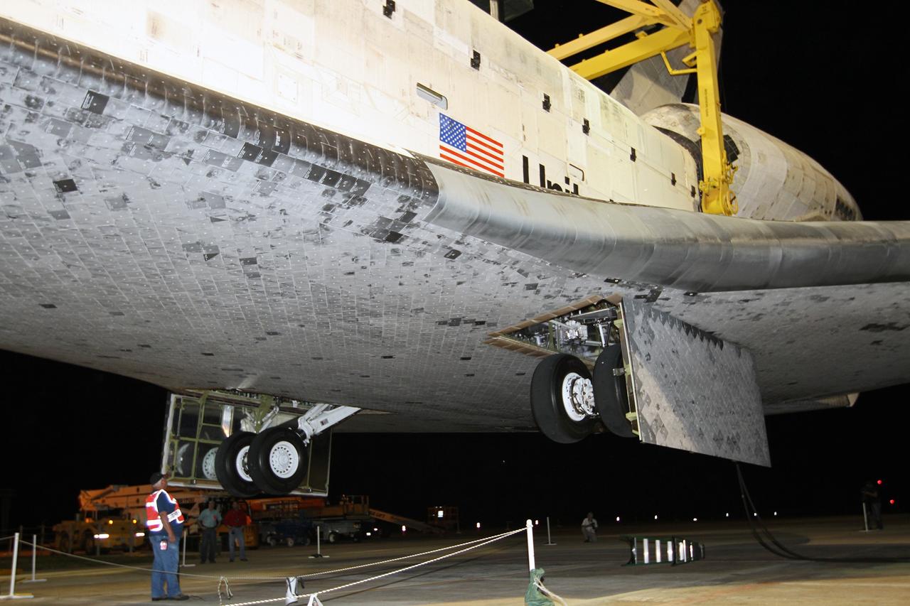 CAPE CANAVERAL, Fla. –At the Shuttle Landing Facility at NASA’s Kennedy Space Center in Florida, space shuttle Discovery rises above the heads of the workers as it is lifted off the ground into the mate-demate device. Operations are under way to position Discovery on top of a Shuttle Carrier Aircraft in preparation for its departure from Kennedy on Tuesday.    The device, known as the MDD, is a large gantry-like steel structure used to hoist a shuttle off the ground and position it onto the back of the aircraft, or SCA. The SCA is a Boeing 747 jet, originally manufactured for commercial use, which was modified by NASA to transport the shuttles between destinations on Earth. The SCA designated NASA 905 is assigned to the remaining ferry missions, delivering the shuttles to their permanent public display sites.  NASA 905 is scheduled to ferry Discovery to the Washington Dulles International Airport in Virginia on April 17, after which the shuttle will be placed on display in the Smithsonian's National Air and Space Museum Steven F. Udvar-Hazy Center. For more information on the SCA, visit http://www.nasa.gov/centers/dryden/news/FactSheets/FS-013-DFRC.html. For more information on shuttle transition and retirement activities, visit http://www.nasa.gov/transition. Photo credit: NASA/Kim Shiflett