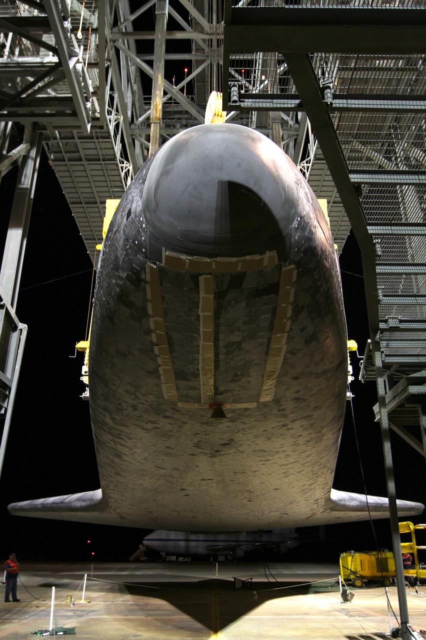 CAPE CANAVERAL, Fla. – At the Shuttle Landing Facility at NASA’s Kennedy Space Center in Florida, a crane on the mate-demate device lifts space shuttle Discovery from the ground. Operations are under way to position Discovery on top of a Shuttle Carrier Aircraft in preparation for its departure from Kennedy on Tuesday.    The device, known as the MDD, is a large gantry-like steel structure used to hoist a shuttle off the ground and position it onto the back of the aircraft, or SCA. The SCA is a Boeing 747 jet, originally manufactured for commercial use, which was modified by NASA to transport the shuttles between destinations on Earth. The SCA designated NASA 905 is assigned to the remaining ferry missions, delivering the shuttles to their permanent public display sites.  NASA 905 is scheduled to ferry Discovery to the Washington Dulles International Airport in Virginia on April 17, after which the shuttle will be placed on display in the Smithsonian's National Air and Space Museum Steven F. Udvar-Hazy Center. For more information on the SCA, visit http://www.nasa.gov/centers/dryden/news/FactSheets/FS-013-DFRC.html. For more information on shuttle transition and retirement activities, visit http://www.nasa.gov/transition. Photo credit: NASA/Kim Shiflett
