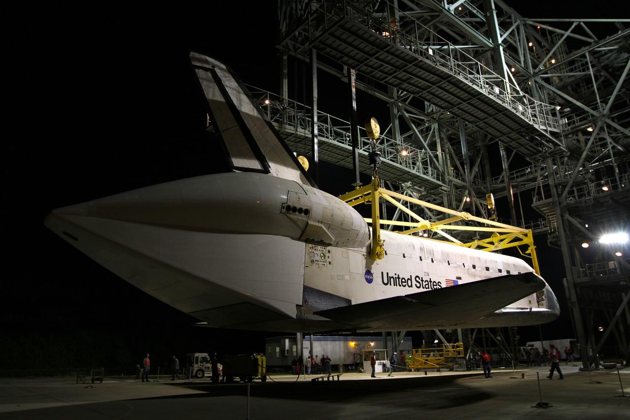 CAPE CANAVERAL, Fla. – Before sunrise at the Shuttle Landing Facility at NASA’s Kennedy Space Center in Florida, space shuttle Discovery is lifted into the mate-demate device by a crane hooked to the yellow sling. Operations have resumed to place Discovery on top of a Shuttle Carrier Aircraft in preparation for its departure from Kennedy on Tuesday.    The device, known as the MDD, is a large gantry-like steel structure used to hoist a shuttle off the ground and position it onto the back of the aircraft, or SCA. The SCA is a Boeing 747 jet, originally manufactured for commercial use, which was modified by NASA to transport the shuttles between destinations on Earth. The SCA designated NASA 905 is assigned to the remaining ferry missions, delivering the shuttles to their permanent public display sites.  NASA 905 is scheduled to ferry Discovery to the Washington Dulles International Airport in Virginia on April 17, after which the shuttle will be placed on display in the Smithsonian's National Air and Space Museum Steven F. Udvar-Hazy Center. For more information on the SCA, visit http://www.nasa.gov/centers/dryden/news/FactSheets/FS-013-DFRC.html. For more information on shuttle transition and retirement activities, visit http://www.nasa.gov/transition. Photo credit: NASA/Kim Shiflett