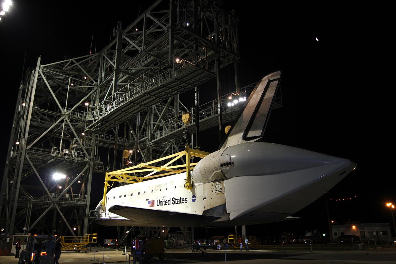 CAPE CANAVERAL, Fla. – Before sunrise at the Shuttle Landing Facility at NASA’s Kennedy Space Center in Florida, space shuttle Discovery is lifted into the mate-demate device by a crane hooked to the yellow sling. Operations have resumed to place Discovery on top of a Shuttle Carrier Aircraft in preparation for its departure from Kennedy on Tuesday. A tail cone has been installed over Discovery’s three replica shuttle main engines to reduce aerodynamic drag and turbulence during the ferry flight. The device, known as the MDD, is a large gantry-like steel structure used to hoist a shuttle off the ground and position it onto the back of the aircraft, or SCA. The SCA is a Boeing 747 jet, originally manufactured for commercial use, which was modified by NASA to transport the shuttles between destinations on Earth. The SCA designated NASA 905 is assigned to the remaining ferry missions, delivering the shuttles to their permanent public display sites. NASA 905 is scheduled to ferry Discovery to the Washington Dulles International Airport in Virginia on April 17, after which the shuttle will be placed on display in the Smithsonian's National Air and Space Museum Steven F. Udvar-Hazy Center. For more information on the SCA, visit http://www.nasa.gov/centers/dryden/news/FactSheets/FS-013-DFRC.html. For more information on shuttle transition and retirement activities, visit http://www.nasa.gov/transition. Photo credit: NASA/Kim Shiflett