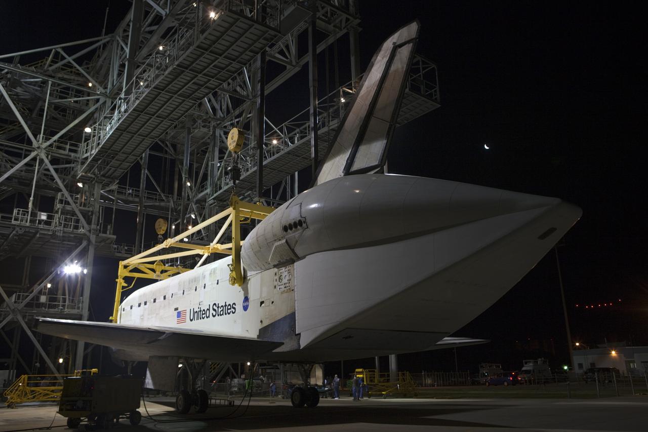 CAPE CANAVERAL, Fla. – Before daybreak at the Shuttle Landing Facility at NASA’s Kennedy Space Center in Florida, a crane on the mate-demate device prepares to lift space shuttle Discovery from the ground. Operations are under way to position Discovery on top of a Shuttle Carrier Aircraft in preparation for its departure from Kennedy on Tuesday. A tail cone has been installed over Discovery’s three replica shuttle main engines to reduce aerodynamic drag and turbulence during the ferry flight. The device, known as the MDD, is a large gantry-like steel structure used to hoist a shuttle off the ground and position it onto the back of the aircraft, or SCA. The SCA is a Boeing 747 jet, originally manufactured for commercial use, which was modified by NASA to transport the shuttles between destinations on Earth. The SCA designated NASA 905 is assigned to the remaining ferry missions, delivering the shuttles to their permanent public display sites. NASA 905 is scheduled to ferry Discovery to the Washington Dulles International Airport in Virginia on April 17, after which the shuttle will be placed on display in the Smithsonian's National Air and Space Museum Steven F. Udvar-Hazy Center. For more information on the SCA, visit http://www.nasa.gov/centers/dryden/news/FactSheets/FS-013-DFRC.html. For more information on shuttle transition and retirement activities, visit http://www.nasa.gov/transition. Photo credit: NASA/Dimitri Gerondidakis