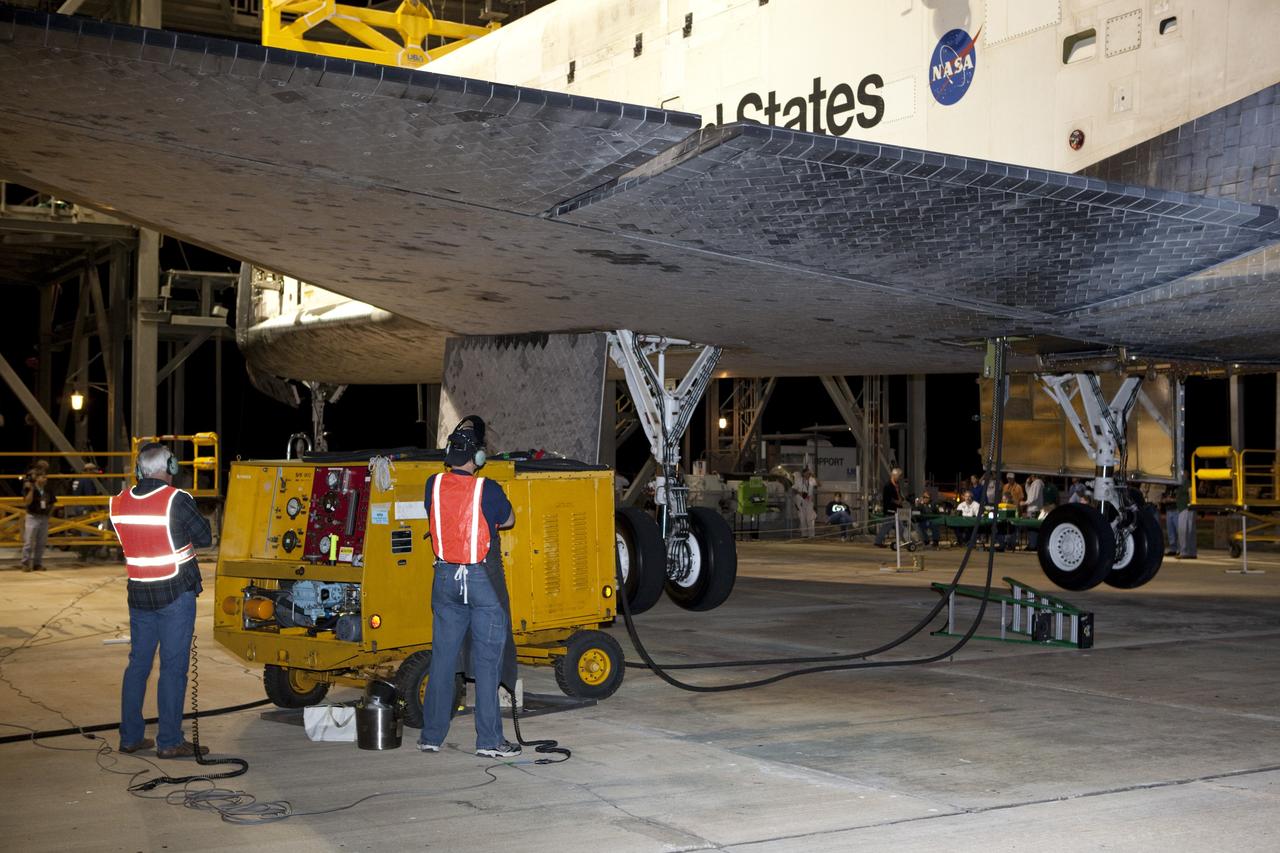 CAPE CANAVERAL, Fla. - At the Shuttle Landing Facility at NASA’s Kennedy Space Center in Florida, operations are under way at the mate-demate device to position Discovery on top of a Shuttle Carrier Aircraft in preparation for its departure from Kennedy on Tuesday.    The device, known as the MDD, is a large gantry-like steel structure used to hoist a shuttle off the ground and position it onto the back of the aircraft, or SCA. The SCA is a Boeing 747 jet, originally manufactured for commercial use, which was modified by NASA to transport the shuttles between destinations on Earth. The SCA designated NASA 905 is assigned to the remaining ferry missions, delivering the shuttles to their permanent public display sites.  NASA 905 is scheduled to ferry Discovery to the Washington Dulles International Airport in Virginia on April 17, after which the shuttle will be placed on display in the Smithsonian's National Air and Space Museum Steven F. Udvar-Hazy Center. For more information on the SCA, visit http://www.nasa.gov/centers/dryden/news/FactSheets/FS-013-DFRC.html. For more information on shuttle transition and retirement activities, visit http://www.nasa.gov/transition. Photo credit: NASA/Dimitri Gerondidakis