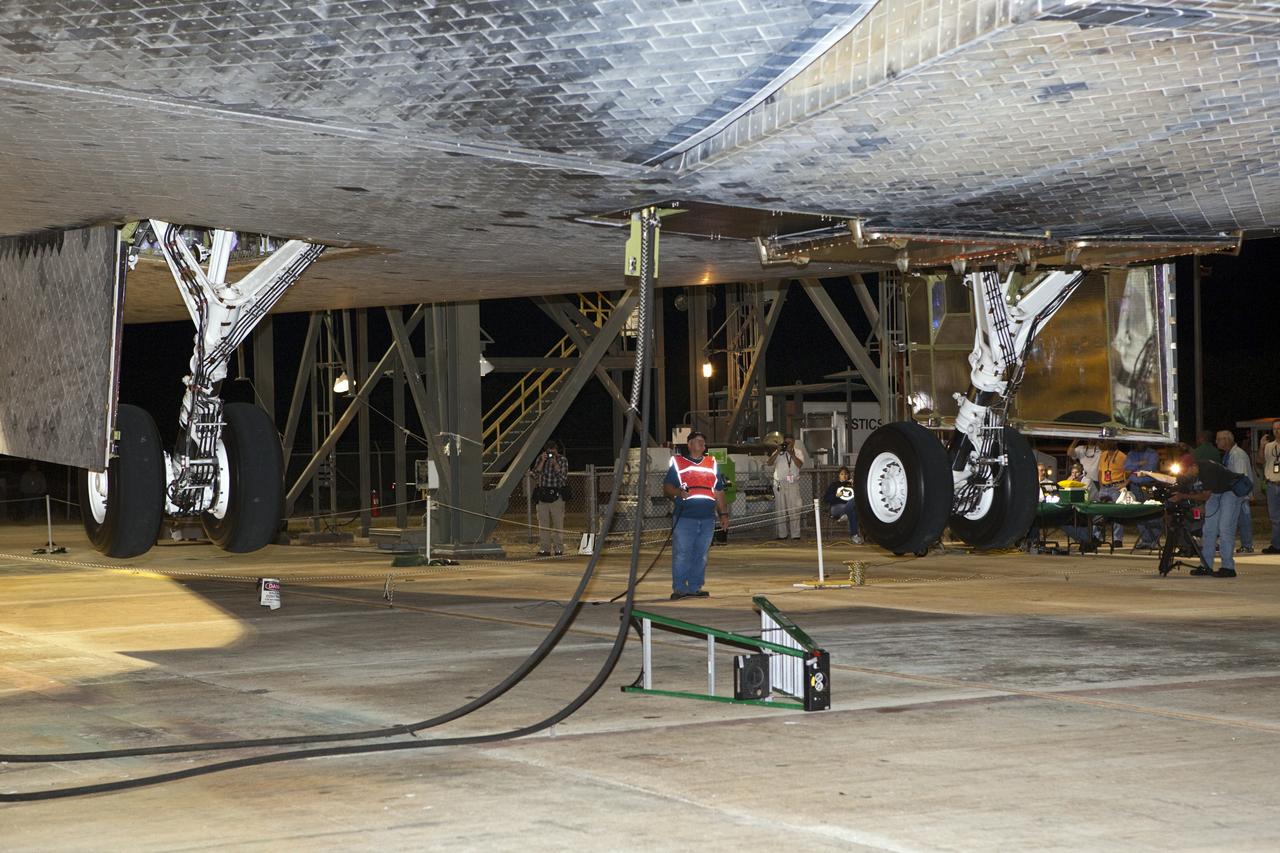 CAPE CANAVERAL, Fla. - At the Shuttle Landing Facility at NASA’s Kennedy Space Center in Florida, final inspections are made on space shuttle Discovery before it is lifted into the mate-demate device and mated to a Shuttle Carrier Aircraft.    The device, known as the MDD, is a large gantry-like steel structure used to hoist a shuttle off the ground and position it onto the back of the aircraft, or SCA. The SCA is a Boeing 747 jet, originally manufactured for commercial use, which was modified by NASA to transport the shuttles between destinations on Earth. The SCA designated NASA 905 is assigned to the remaining ferry missions, delivering the shuttles to their permanent public display sites.  NASA 905 is scheduled to ferry Discovery to the Washington Dulles International Airport in Virginia on April 17, after which the shuttle will be placed on display in the Smithsonian's National Air and Space Museum Steven F. Udvar-Hazy Center. For more information on the SCA, visit http://www.nasa.gov/centers/dryden/news/FactSheets/FS-013-DFRC.html. For more information on shuttle transition and retirement activities, visit http://www.nasa.gov/transition. Photo credit: NASA/Dimitri Gerondidakis