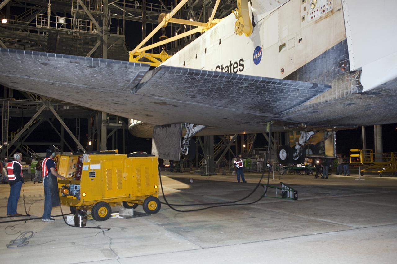 CAPE CANAVERAL, Fla. - At the Shuttle Landing Facility at NASA’s Kennedy Space Center in Florida, workers at the mate-demate device make final preparations to lift and mate space shuttle Discovery to a Shuttle Carrier Aircraft.      The device, known as the MDD, is a large gantry-like steel structure used to hoist a shuttle off the ground and position it onto the back of the aircraft, or SCA. The SCA is a Boeing 747 jet, originally manufactured for commercial use, which was modified by NASA to transport the shuttles between destinations on Earth. The SCA designated NASA 905 is assigned to the remaining ferry missions, delivering the shuttles to their permanent public display sites.  NASA 905 is scheduled to ferry Discovery to the Washington Dulles International Airport in Virginia on April 17, after which the shuttle will be placed on display in the Smithsonian's National Air and Space Museum Steven F. Udvar-Hazy Center. For more information on the SCA, visit http://www.nasa.gov/centers/dryden/news/FactSheets/FS-013-DFRC.html. For more information on shuttle transition and retirement activities, visit http://www.nasa.gov/transition. Photo credit: NASA/Dimitri Gerondidakis