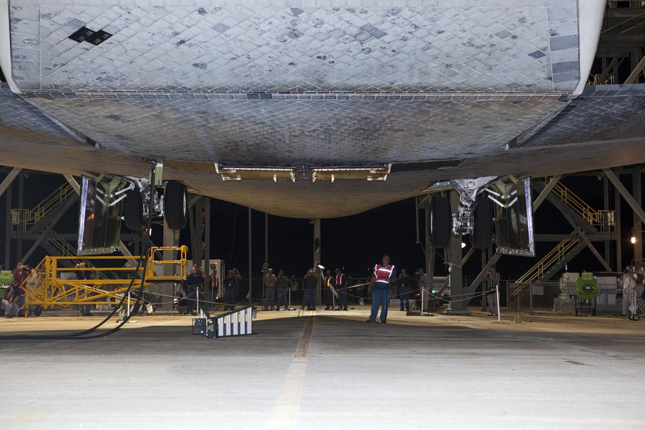 CAPE CANAVERAL, Fla. - At the Shuttle Landing Facility at NASA’s Kennedy Space Center in Florida, final inspections are made of space shuttle Discovery before it is lifted into the mate-demate device and lowered onto the top of a Shuttle Carrier Aircraft.    The device, known as the MDD, is a large gantry-like steel structure used to hoist a shuttle off the ground and position it onto the back of the aircraft, or SCA. The SCA is a Boeing 747 jet, originally manufactured for commercial use, which was modified by NASA to transport the shuttles between destinations on Earth. The SCA designated NASA 905 is assigned to the remaining ferry missions, delivering the shuttles to their permanent public display sites.  NASA 905 is scheduled to ferry Discovery to the Washington Dulles International Airport in Virginia on April 17, after which the shuttle will be placed on display in the Smithsonian's National Air and Space Museum Steven F. Udvar-Hazy Center. For more information on the SCA, visit http://www.nasa.gov/centers/dryden/news/FactSheets/FS-013-DFRC.html. For more information on shuttle transition and retirement activities, visit http://www.nasa.gov/transition. Photo credit: NASA/Dimitri Gerondidakis