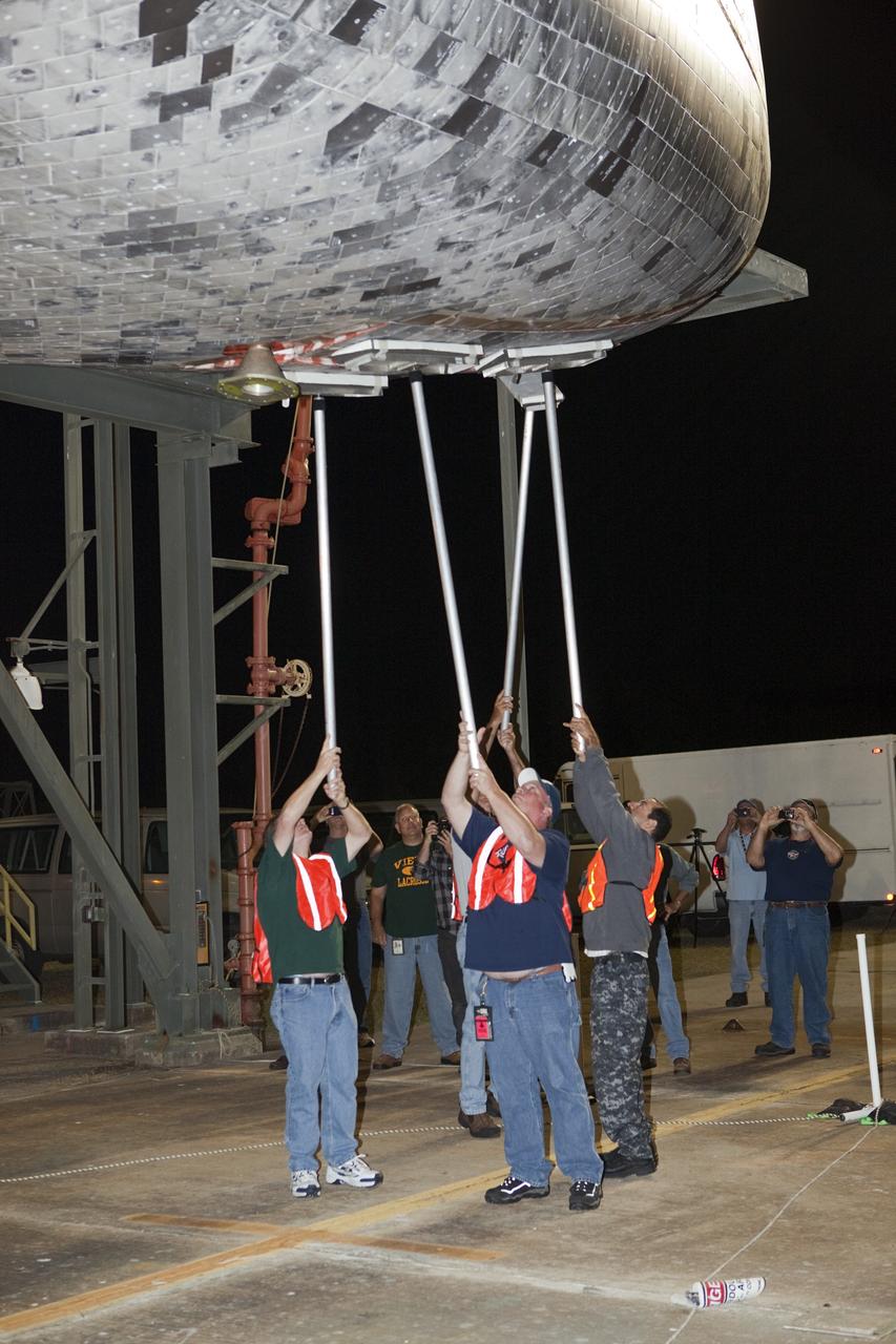 CAPE CANAVERAL, Fla. - At the Shuttle Landing Facility at NASA’s Kennedy Space Center in Florida, workers at the mate-demate device complete final preparations to lift and mate space shuttle Discovery to a Shuttle Carrier Aircraft.    The device, known as the MDD, is a large gantry-like steel structure used to hoist a shuttle off the ground and position it onto the back of the aircraft, or SCA. The SCA is a Boeing 747 jet, originally manufactured for commercial use, which was modified by NASA to transport the shuttles between destinations on Earth. The SCA designated NASA 905 is assigned to the remaining ferry missions, delivering the shuttles to their permanent public display sites.  NASA 905 is scheduled to ferry Discovery to the Washington Dulles International Airport in Virginia on April 17, after which the shuttle will be placed on display in the Smithsonian's National Air and Space Museum Steven F. Udvar-Hazy Center. For more information on the SCA, visit http://www.nasa.gov/centers/dryden/news/FactSheets/FS-013-DFRC.html. For more information on shuttle transition and retirement activities, visit http://www.nasa.gov/transition. Photo credit: NASA/Dimitri Gerondidakis