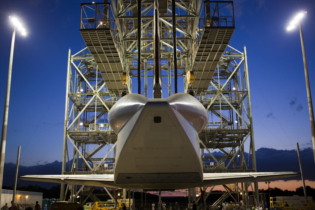 CAPE CANAVERAL, Fla. – Before daybreak at the Shuttle Landing Facility at NASA’s Kennedy Space Center in Florida, operations are under way at the mate-demate device to lift space shuttle Discovery on top of a Shuttle Carrier Aircraft. A tail cone has been installed over Discovery’s three replica shuttle main engines to reduce aerodynamic drag and turbulence during the ferry flight.    The device, known as the MDD, is a large gantry-like steel structure used to hoist a shuttle off the ground and position it onto the back of the aircraft, or SCA. The SCA is a Boeing 747 jet, originally manufactured for commercial use, which was modified by NASA to transport the shuttles between destinations on Earth. The SCA designated NASA 905 is assigned to the remaining ferry missions, delivering the shuttles to their permanent public display sites.  NASA 905 is scheduled to ferry Discovery to the Washington Dulles International Airport in Virginia on April 17, after which the shuttle will be placed on display in the Smithsonian's National Air and Space Museum Steven F. Udvar-Hazy Center. For more information on the SCA, visit http://www.nasa.gov/centers/dryden/news/FactSheets/FS-013-DFRC.html. For more information on shuttle transition and retirement activities, visit http://www.nasa.gov/transition. Photo credit: NASA/Dimitri Gerondidakis