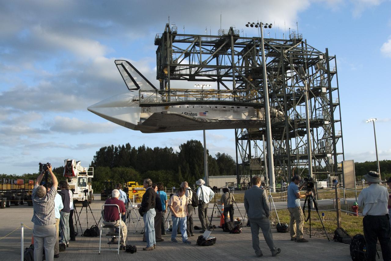 CAPE CANAVERAL, Fla. – At the Shuttle Landing Facility at NASA’s Kennedy Space Center in Florida, media representatives are on hand as space shuttle Discovery is lifted 60 feet off the ground inside the mate-demate device in preparation for the arrival of the Shuttle Carrier Aircraft. The device, known as the MDD, is a large gantry-like steel structure used to hoist a shuttle off the ground and position it onto the back of the aircraft, or SCA. The SCA is a Boeing 747 jet, originally manufactured for commercial use, which was modified by NASA to transport the shuttles between destinations on Earth. The SCA designated NASA 905 is assigned to the remaining ferry missions, delivering the shuttles to their permanent public display sites.  NASA 905 is scheduled to ferry Discovery to the Washington Dulles International Airport in Virginia on April 17, after which the shuttle will be placed on display in the Smithsonian's National Air and Space Museum Steven F. Udvar-Hazy Center. For more information on the SCA, visit http://www.nasa.gov/centers/dryden/news/FactSheets/FS-013-DFRC.html. For more information on shuttle transition and retirement activities, visit http://www.nasa.gov/transition.  Photo credit: NASA/Tim Jacobs