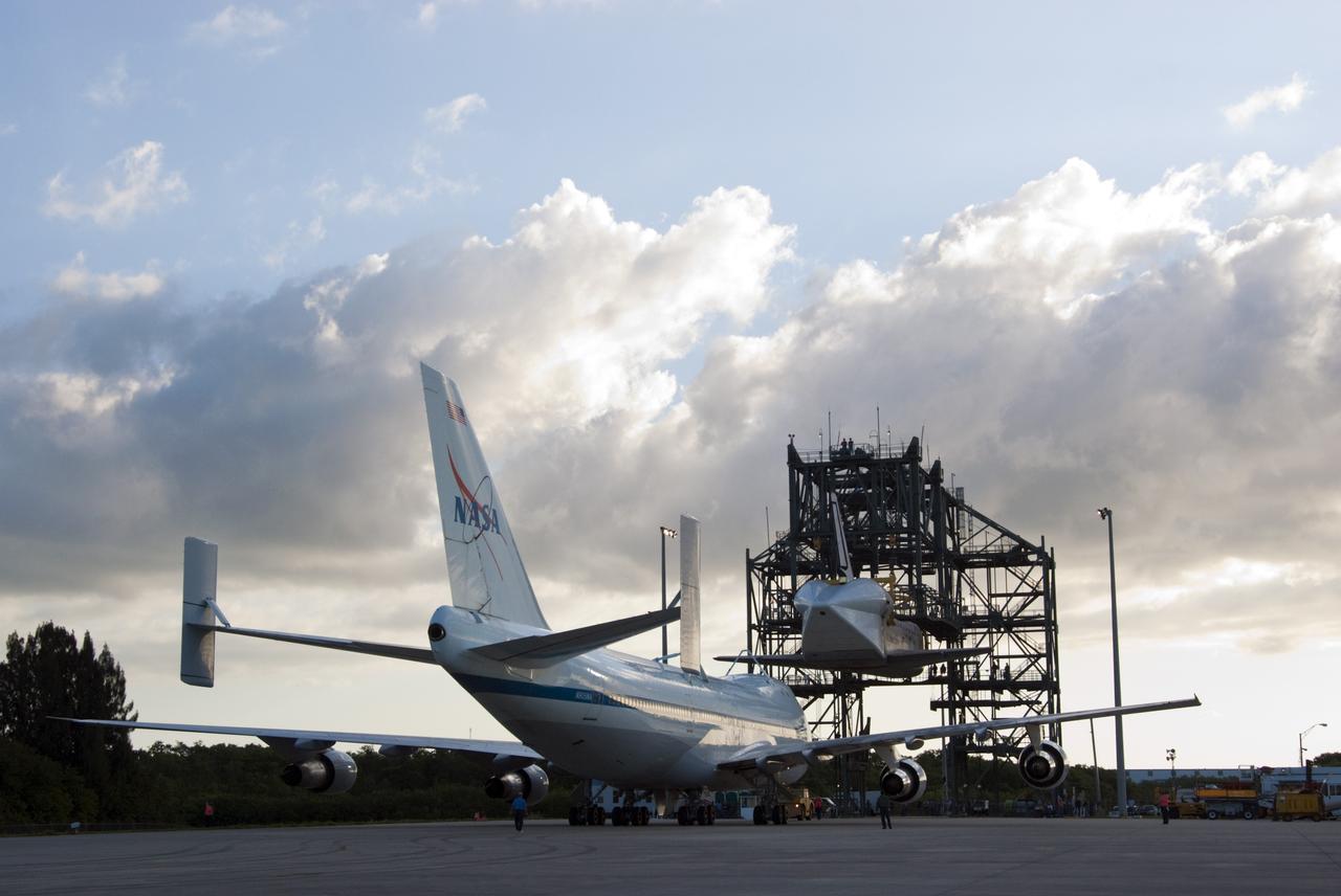 CAPE CANAVERAL, Fla. – At the Shuttle Landing Facility at NASA’s Kennedy Space Center in Florida, the Shuttle Carrier Aircraft moves into position under space shuttle Discovery in the mate-demate device. The device, known as the MDD, is a large gantry-like steel structure used to hoist a shuttle off the ground and position it onto the back of the aircraft, or SCA. This SCA, designated NASA 905, is a Boeing 747 jet originally manufactured for commercial use, which was modified by NASA to transport the shuttles between destinations on Earth. NASA 905 is assigned to the remaining ferry missions, delivering the shuttles to their permanent public display sites. Discovery’s new home will be the Smithsonian's National Air and Space Museum Steven F. Udvar-Hazy Center in Chantilly, Va. For more information on the SCA, visit http://www.nasa.gov/centers/dryden/news/FactSheets/FS-013-DFRC.html. For more information on shuttle transition and retirement activities, visit http://www.nasa.gov/transition. Photo credit: NASA/Tim Jacobs