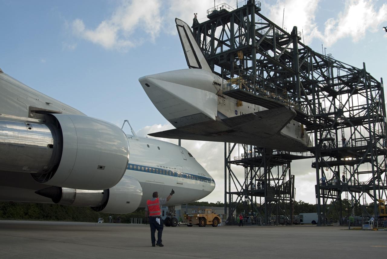 CAPE CANAVERAL, Fla. – At the Shuttle Landing Facility at NASA’s Kennedy Space Center in Florida, the Shuttle Carrier Aircraft moves into position under space shuttle Discovery suspended 60 feet off the ground in the mate-demate device. The device, known as the MDD, is a large gantry-like steel structure used to hoist a shuttle off the ground and position it onto the back of the aircraft, or SCA. This SCA, designated NASA 905, is a Boeing 747 jet originally manufactured for commercial use, which was modified by NASA to transport the shuttles between destinations on Earth. NASA 905 is assigned to the remaining ferry missions, delivering the shuttles to their permanent public display sites. Discovery’s new home will be the Smithsonian's National Air and Space Museum Steven F. Udvar-Hazy Center in Chantilly, Va. For more information on the SCA, visit http://www.nasa.gov/centers/dryden/news/FactSheets/FS-013-DFRC.html. For more information on shuttle transition and retirement activities, visit http://www.nasa.gov/transition. Photo credit: NASA/Tim Jacobs