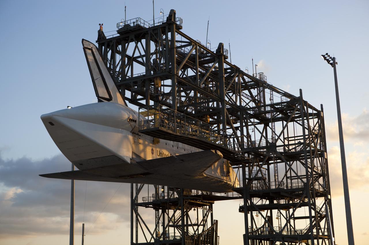 CAPE CANAVERAL, Fla. – At the Shuttle Landing Facility at NASA’s Kennedy Space Center in Florida, space shuttle Discovery is suspended 60 feet off the ground inside the mate-demate device in preparation for the arrival of the Shuttle Carrier Aircraft.  The device, known as the MDD, is a large gantry-like steel structure used to hoist a shuttle off the ground and position it onto the back of the aircraft, or SCA. The SCA is a Boeing 747 jet, originally manufactured for commercial use, which was modified by NASA to transport the shuttles between destinations on Earth. The SCA designated NASA 905 is assigned to the remaining ferry missions, delivering the shuttles to their permanent public display sites.  NASA 905 is scheduled to ferry Discovery to the Washington Dulles International Airport in Virginia on April 17, after which the shuttle will be placed on display in the Smithsonian's National Air and Space Museum Steven F. Udvar-Hazy Center. For more information on the SCA, visit http://www.nasa.gov/centers/dryden/news/FactSheets/FS-013-DFRC.html. For more information on shuttle transition and retirement activities, visit http://www.nasa.gov/transition.  Photo credit: NASA/Dimitri Gerondidakis