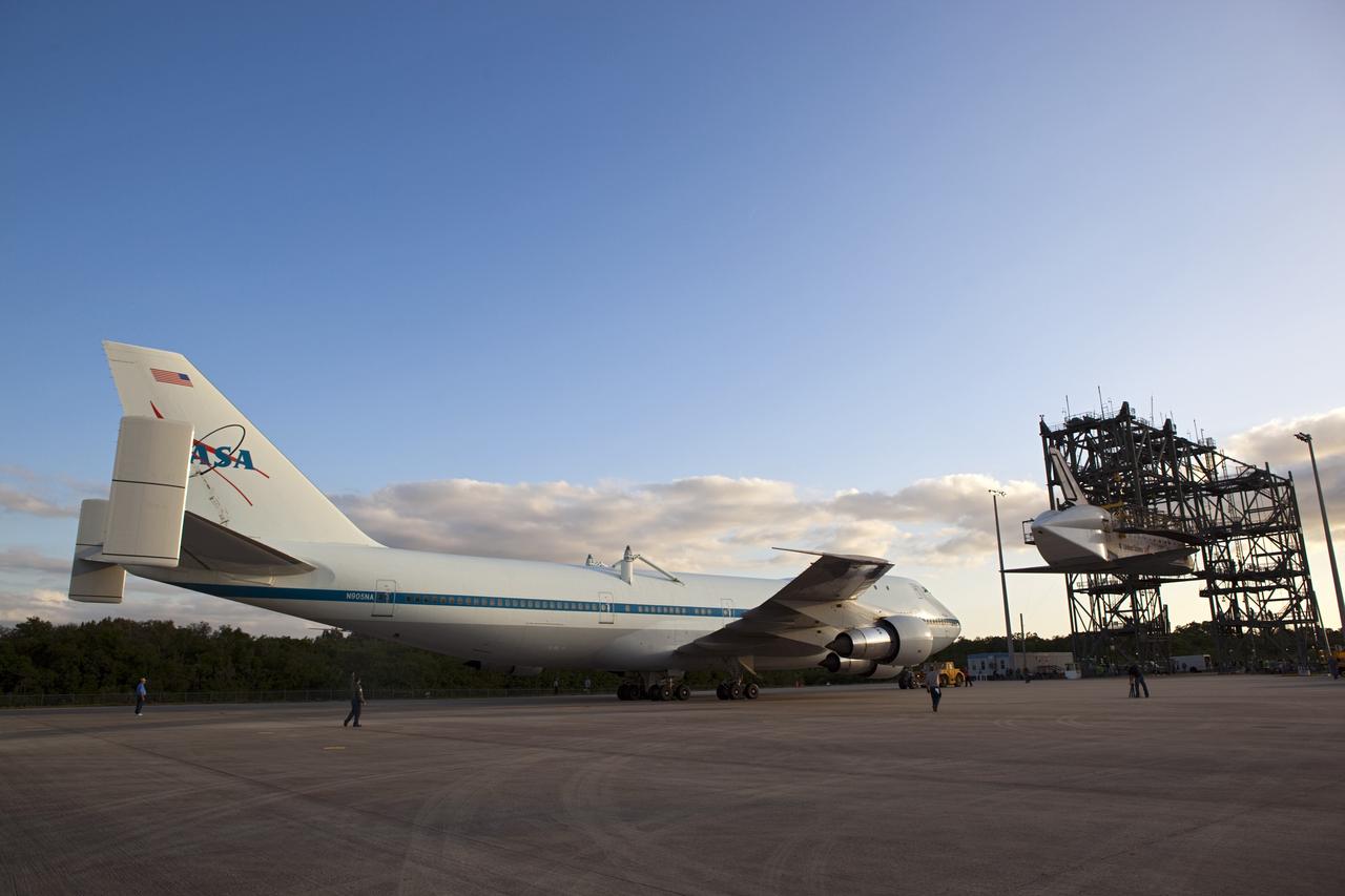 CAPE CANAVERAL, Fla. – At the Shuttle Landing Facility at NASA’s Kennedy Space Center in Florida, the Shuttle Carrier Aircraft moves into position under space shuttle Discovery suspended 60 feet off the ground in the mate-demate device. The device, known as the MDD, is a large gantry-like steel structure used to hoist a shuttle off the ground and position it onto the back of the aircraft, or SCA. This SCA, designated NASA 905, is a Boeing 747 jet originally manufactured for commercial use, which was modified by NASA to transport the shuttles between destinations on Earth. NASA 905 is assigned to the remaining ferry missions, delivering the shuttles to their permanent public display sites. Discovery’s new home will be the Smithsonian's National Air and Space Museum Steven F. Udvar-Hazy Center in Chantilly, Va. For more information on the SCA, visit http://www.nasa.gov/centers/dryden/news/FactSheets/FS-013-DFRC.html. For more information on shuttle transition and retirement activities, visit http://www.nasa.gov/transition. Photo credit: NASA/Dimitri Gerondidakis
